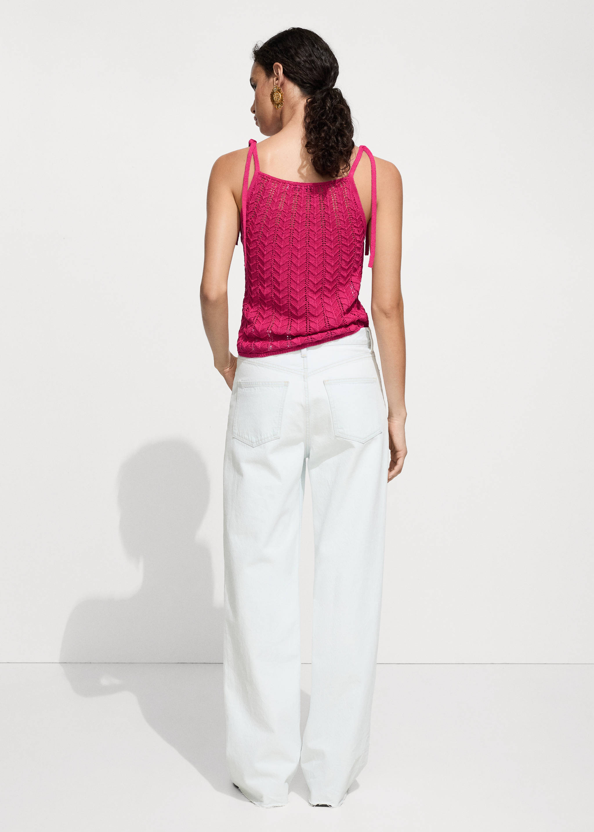 Openwork knitted top with bows - Reverse of the article