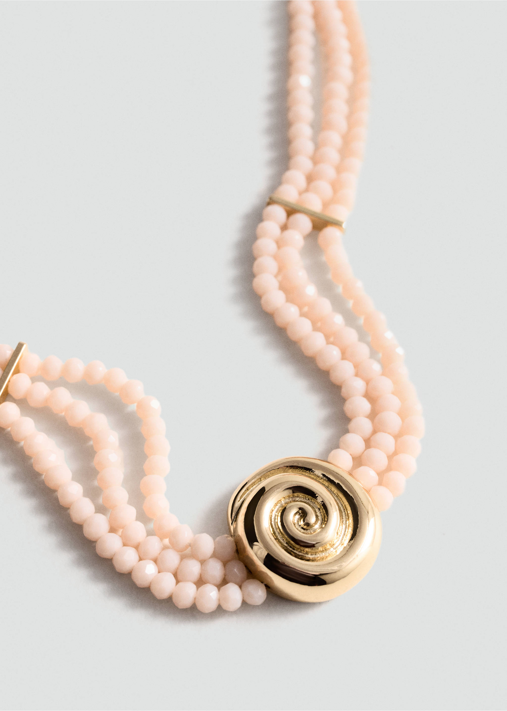 Pale pink beaded collar necklace with a gold-tone swirl pendant., Gold. Ref: 77060348-00.