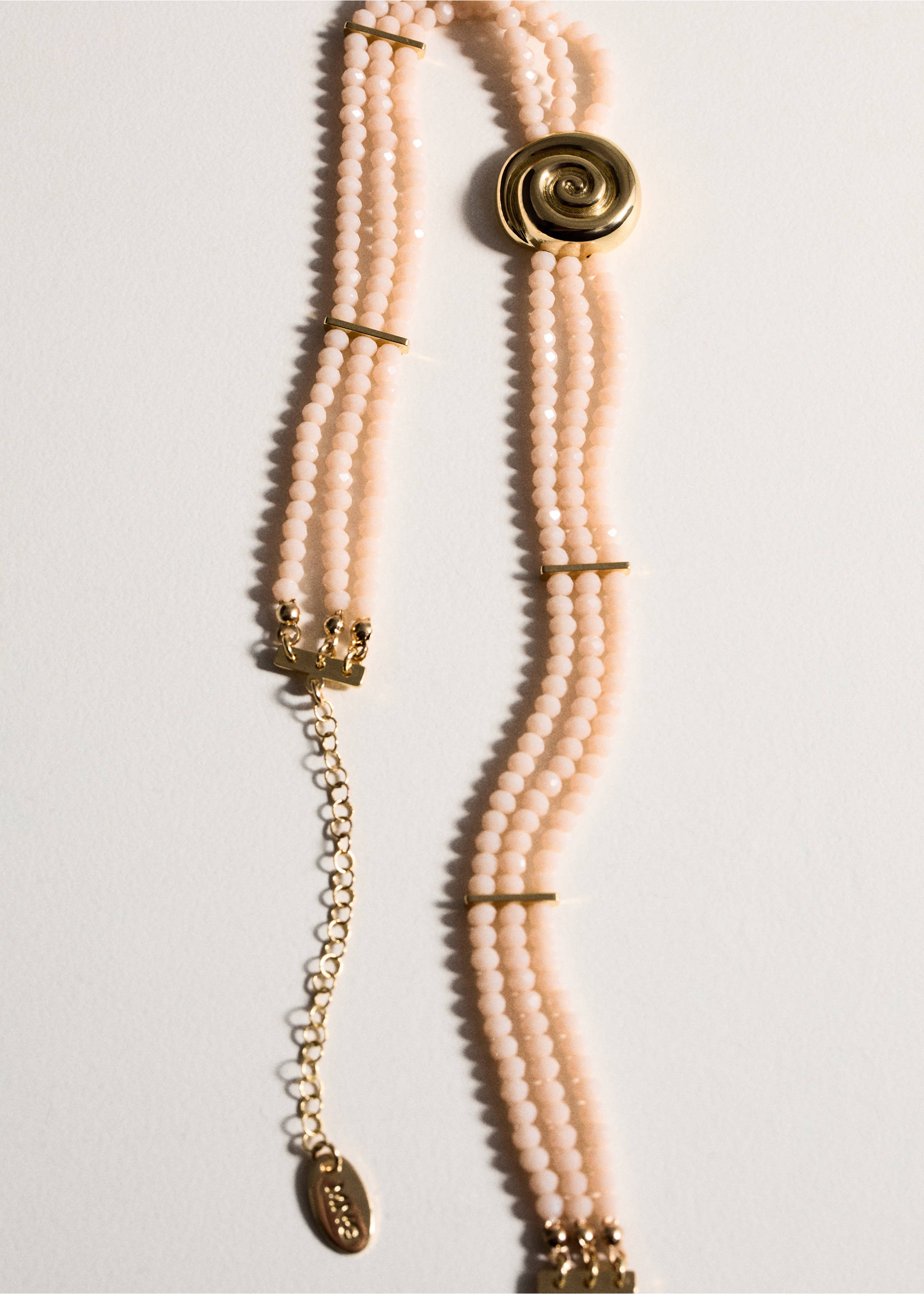 Pale pink beaded multi-strand collar necklace with gold-tone metal bars and a spiral detail., Gold. Ref: 77060348-00.