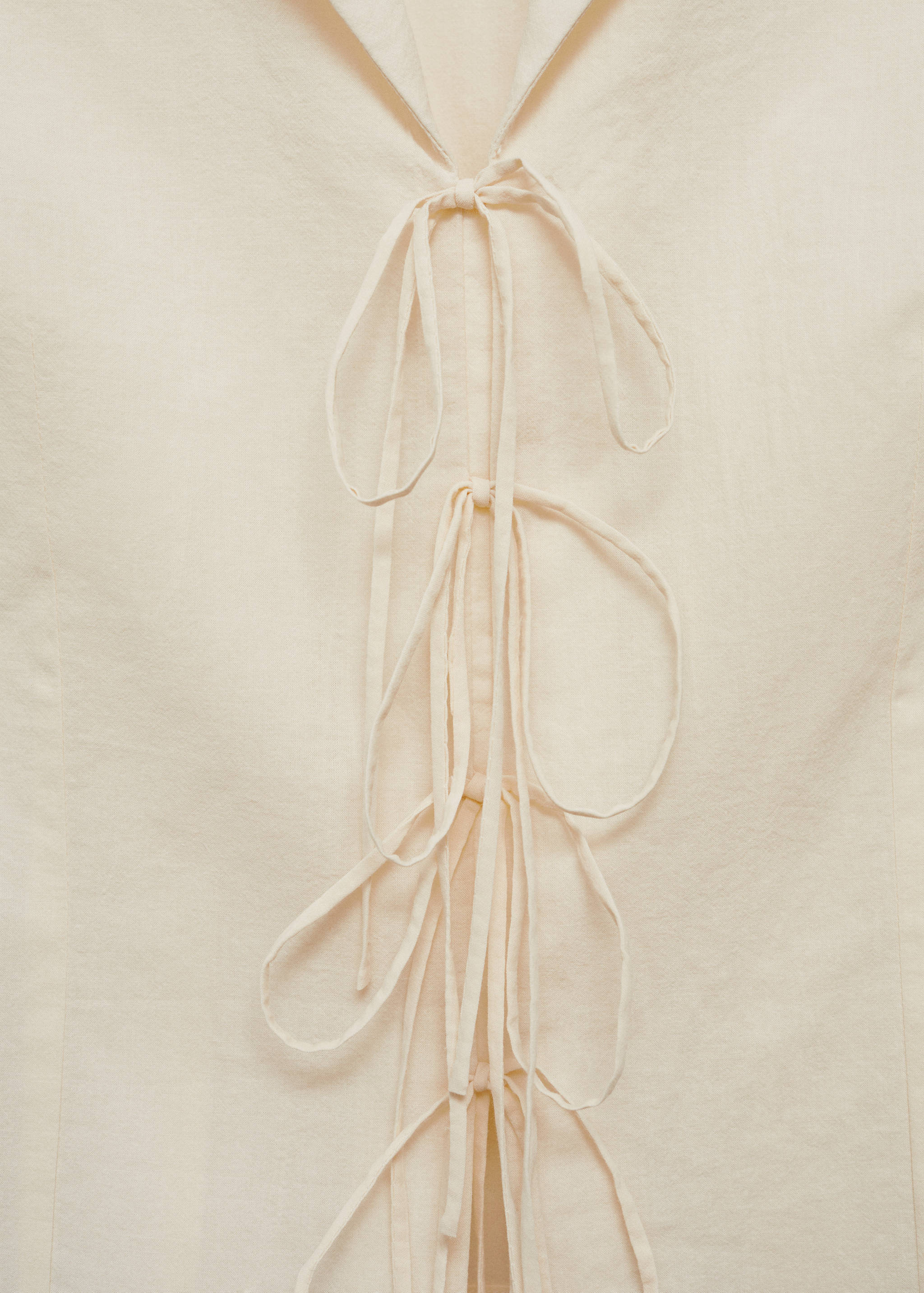 Sleeveless blouse with bows - Details of the article 0