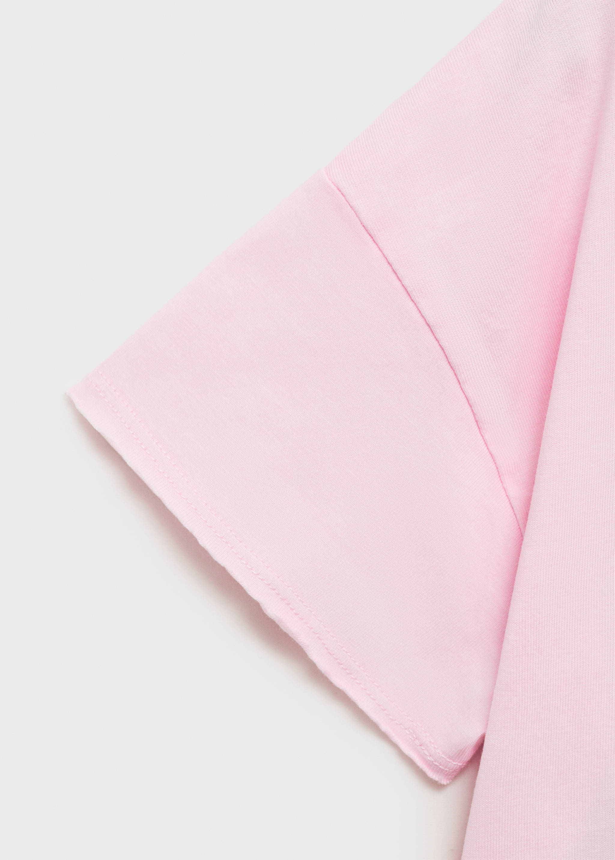Close-up of the short sleeve on a pink t-shirt.