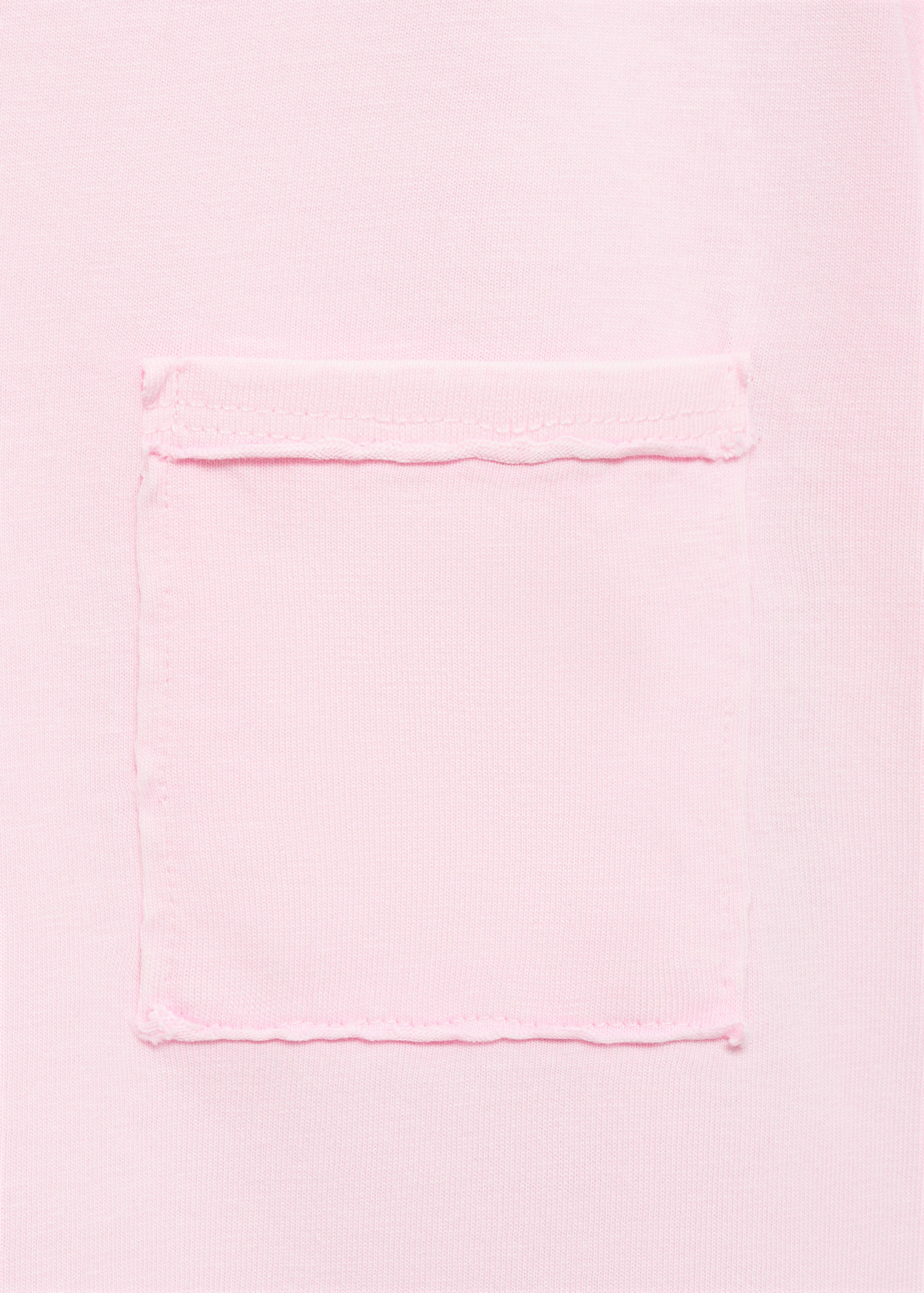 Close-up of a pink t-shirt showing the chest pocket detail.