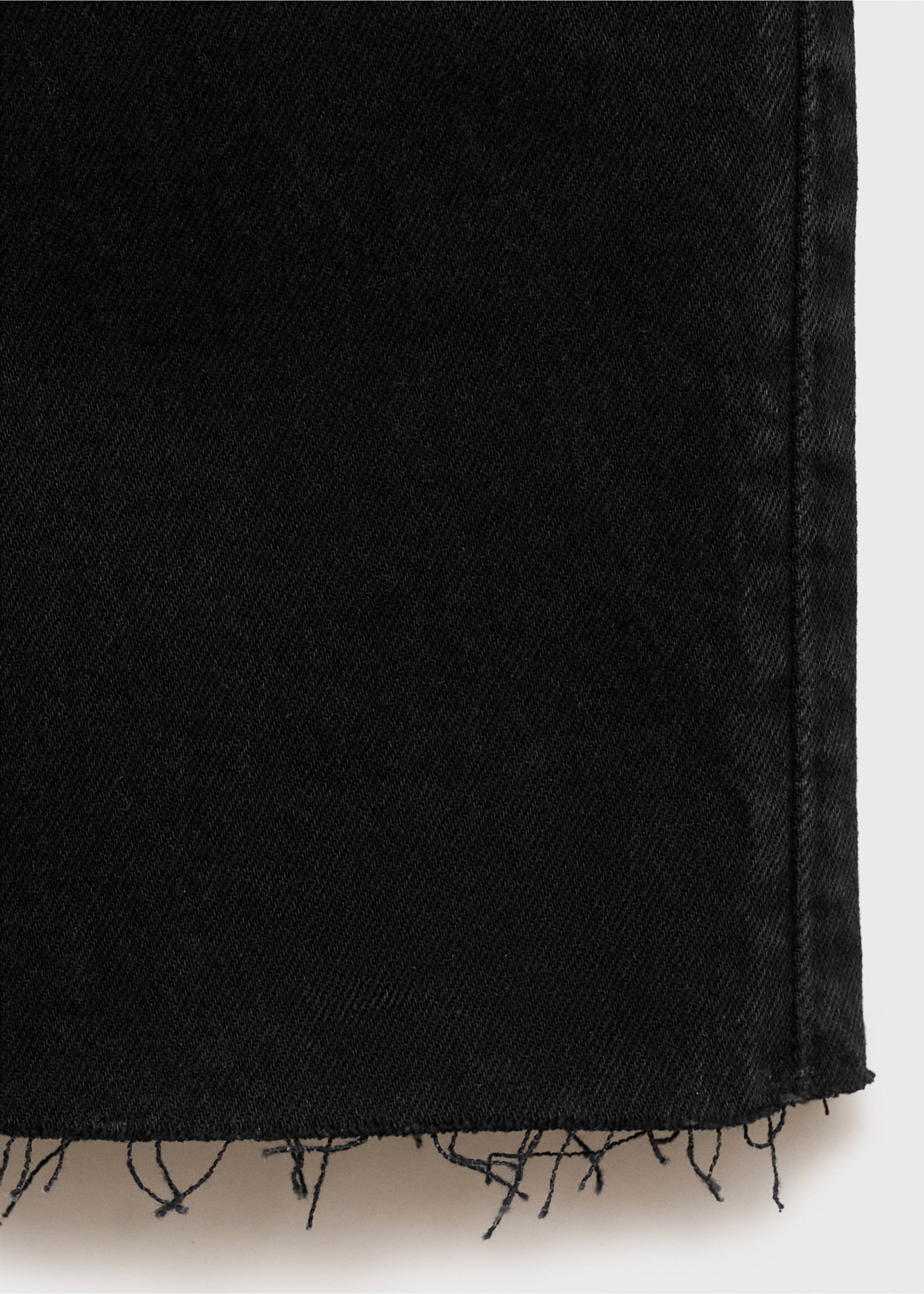 Close-up of black denim fabric texture and frayed hem., Black denim. Ref: 87010266-00.