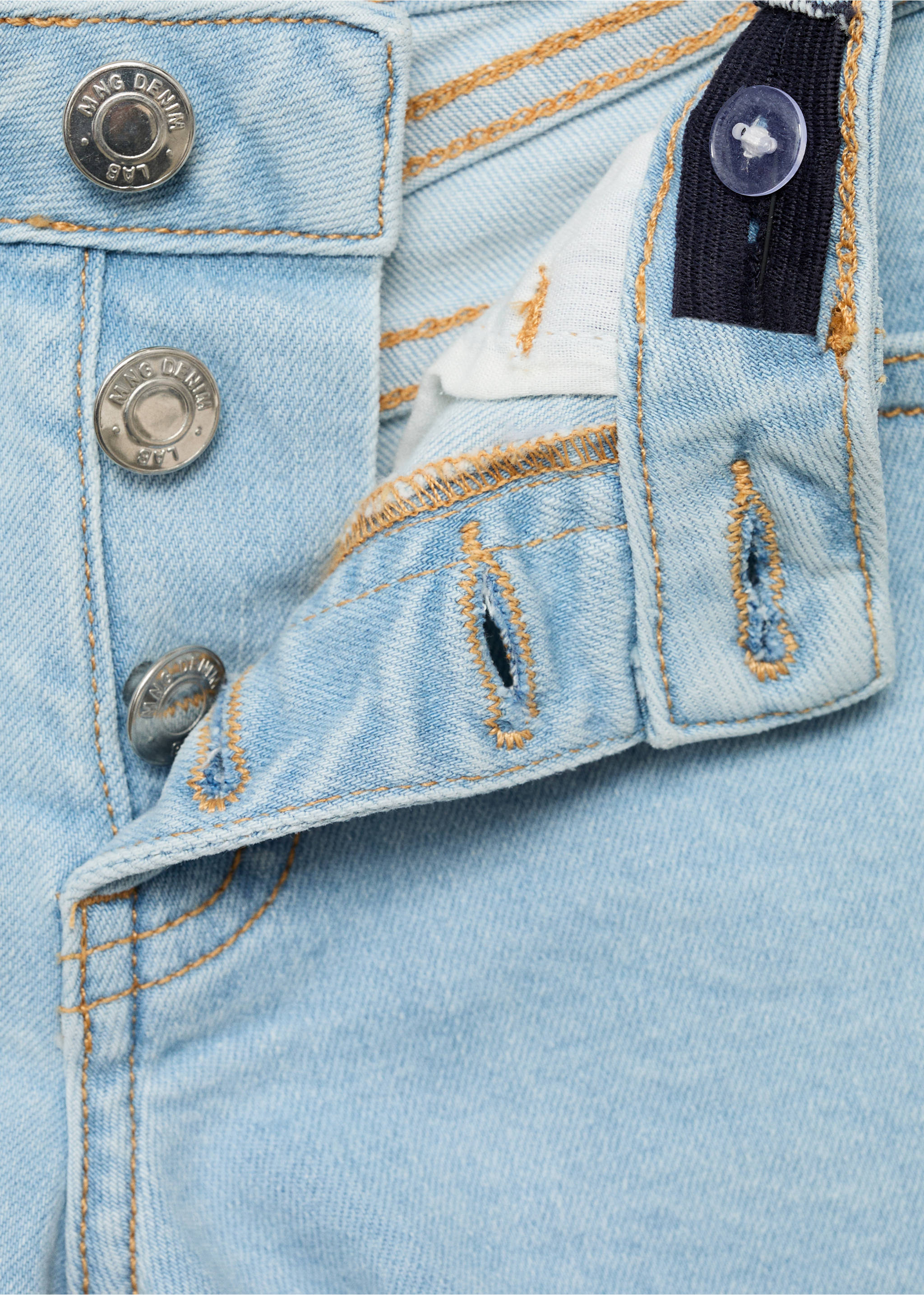 Close-up of the button fly and waistband of light wash denim shorts., Light Blue. Ref: 87025947-00.