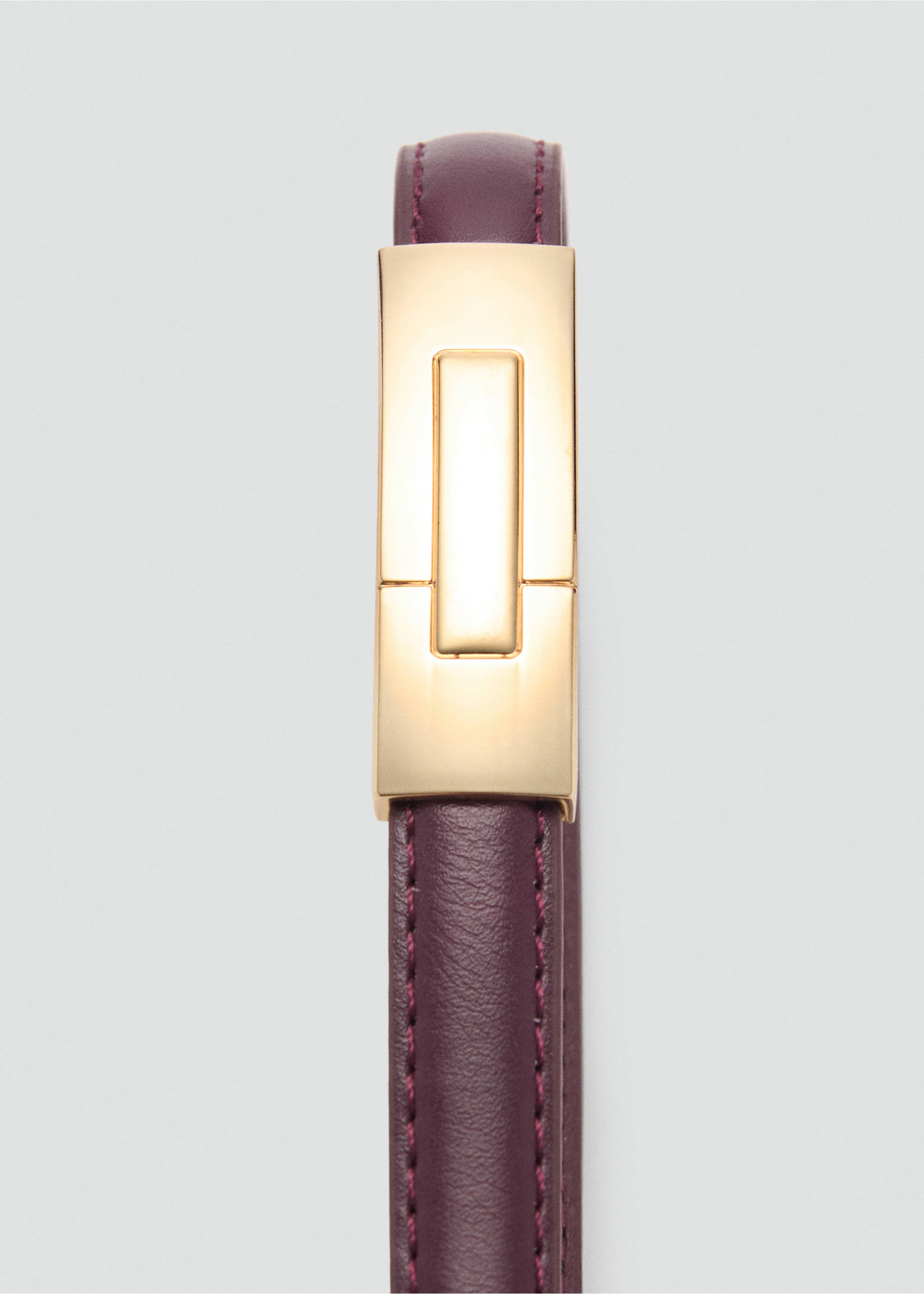 Close-up of a burgundy leather belt with a rectangular gold buckle., Burgundy. Ref: 87030432-00.