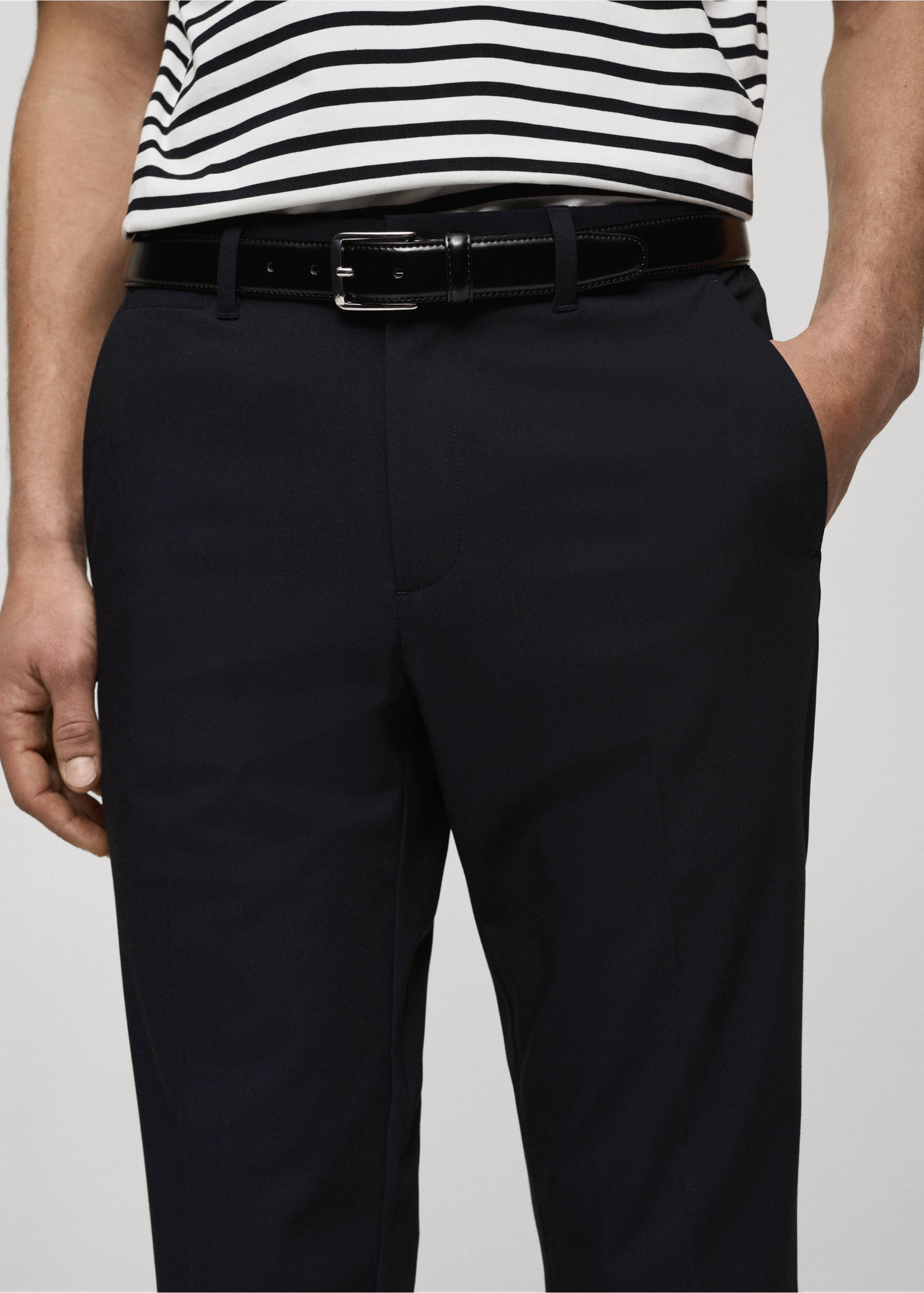 Navy blue trousers with a black leather belt, shown in a close-up., Dark Navy. Ref: 87032889-00.