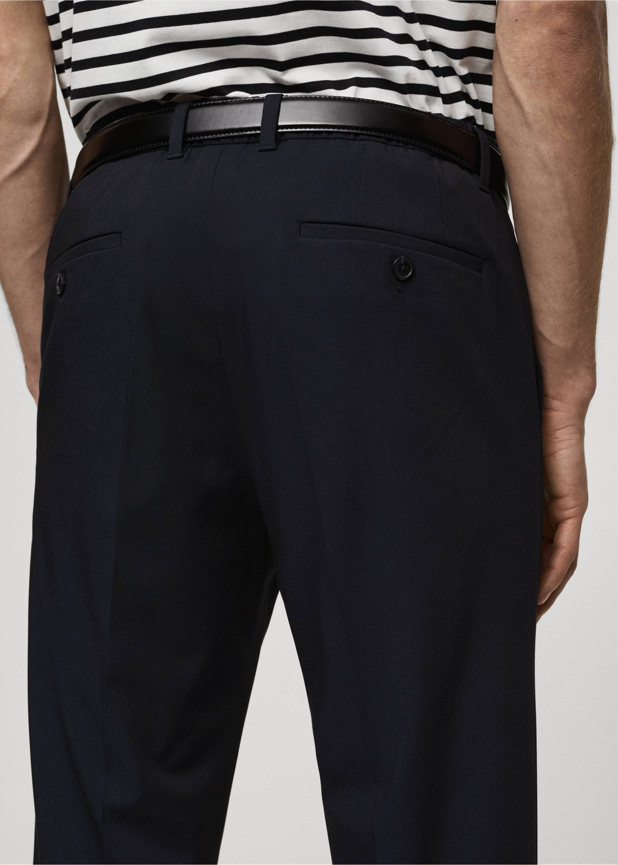 Navy blue trousers seen from the back, featuring buttoned welt pockets and a black leather belt., Dark Navy. Ref: 87032889-00.
