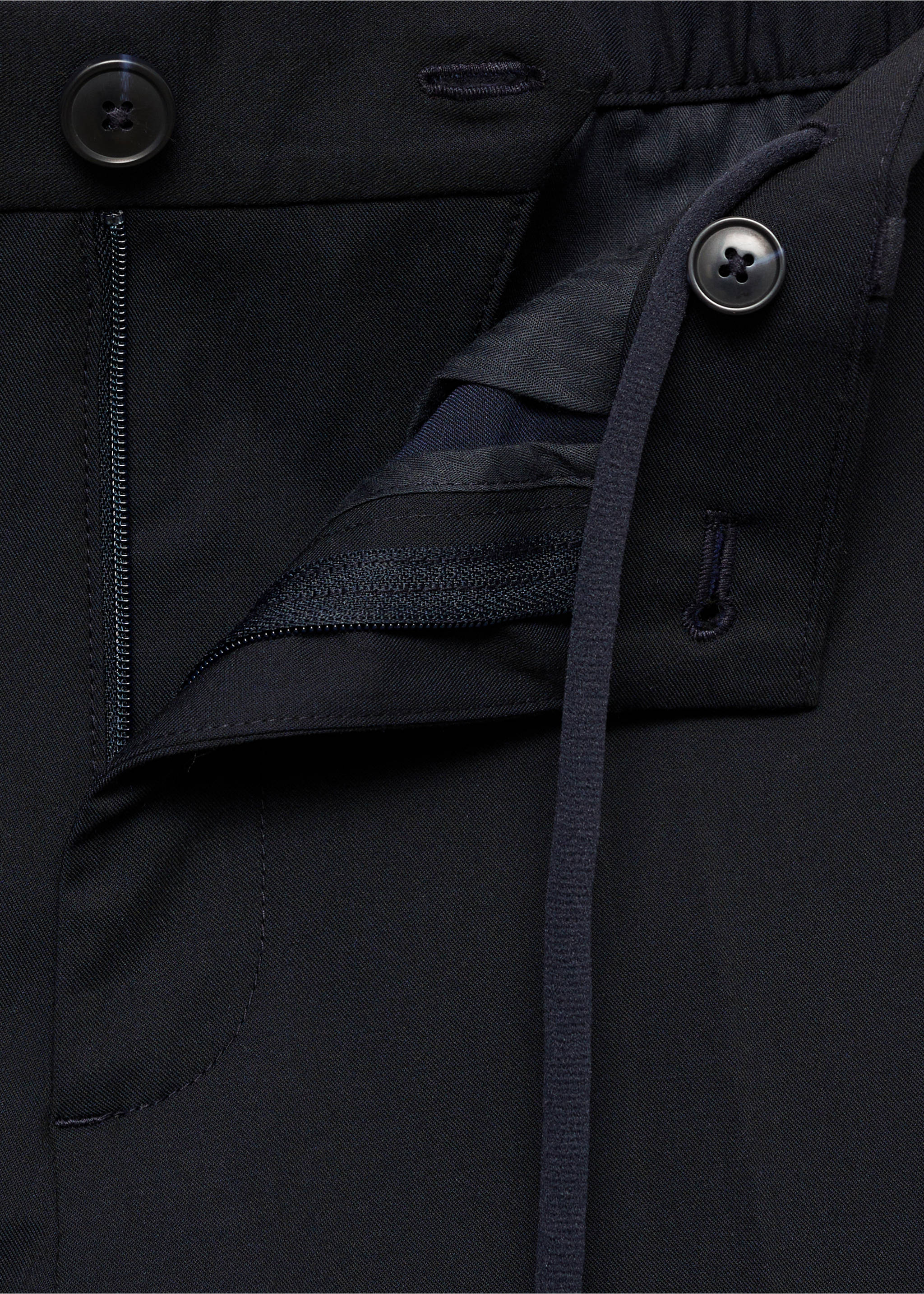 Close-up of navy blue trousers showing the waistband and button fly., Dark Navy. Ref: 87032889-00.