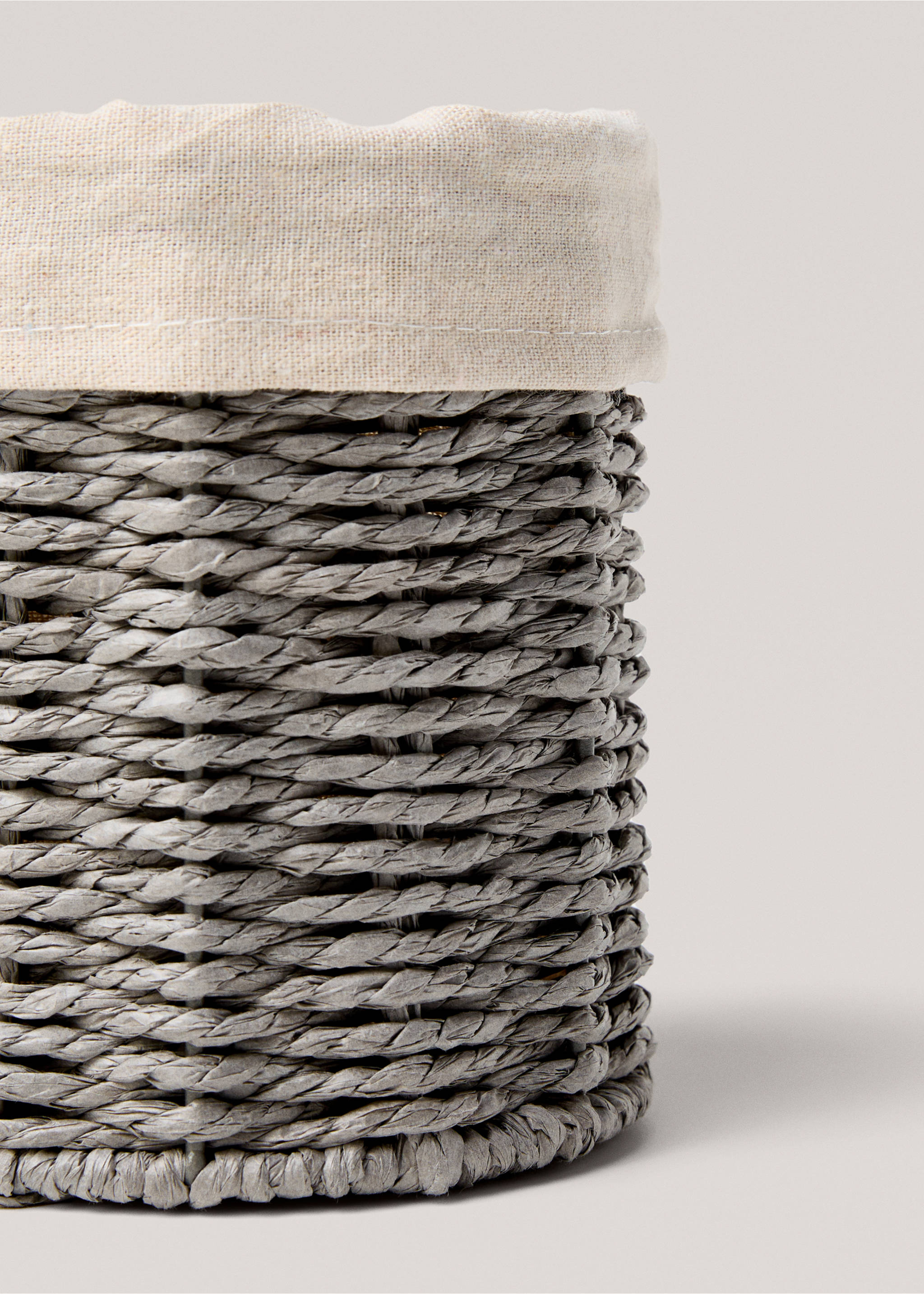 Close-up of a grey woven basket with a light beige fabric lining., Grey. Ref: 87032898-00.