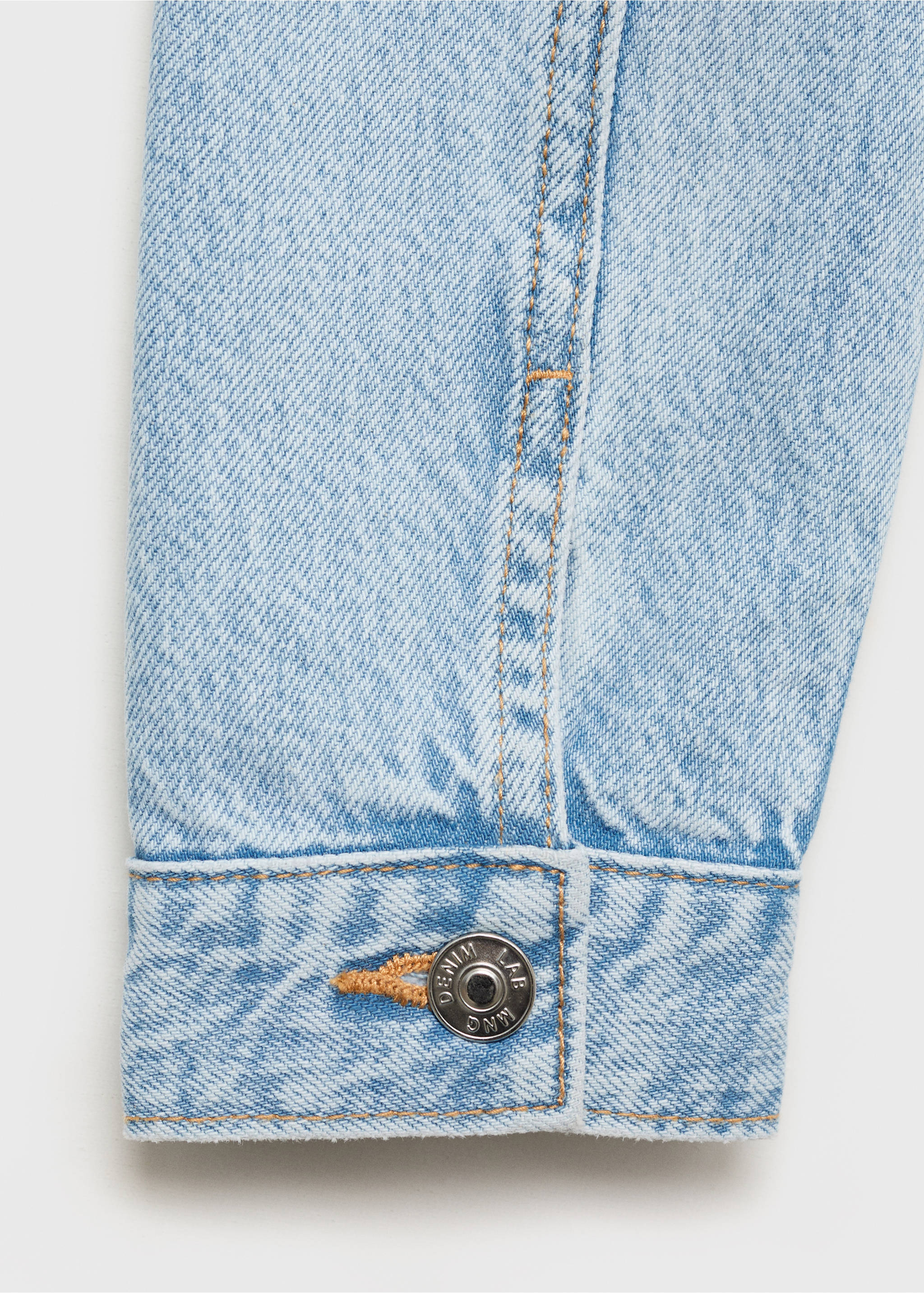 Close-up of a light blue denim jacket cuff with contrast stitching., Light Blue. Ref: 87045952-00.
