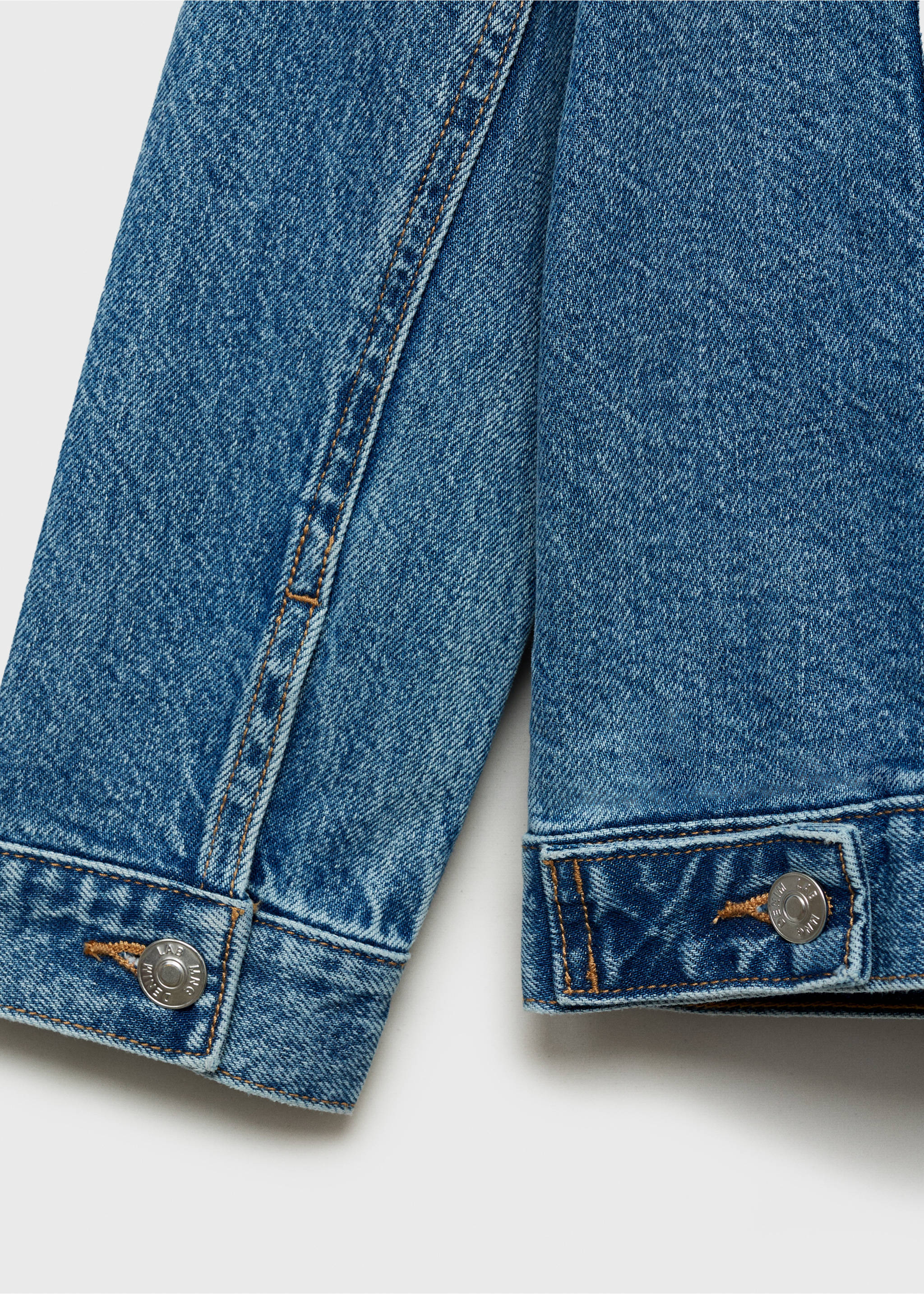 Close-up of blue denim jacket fabric, stitching and cuffs., Medium Blue. Ref: 87045952-00.