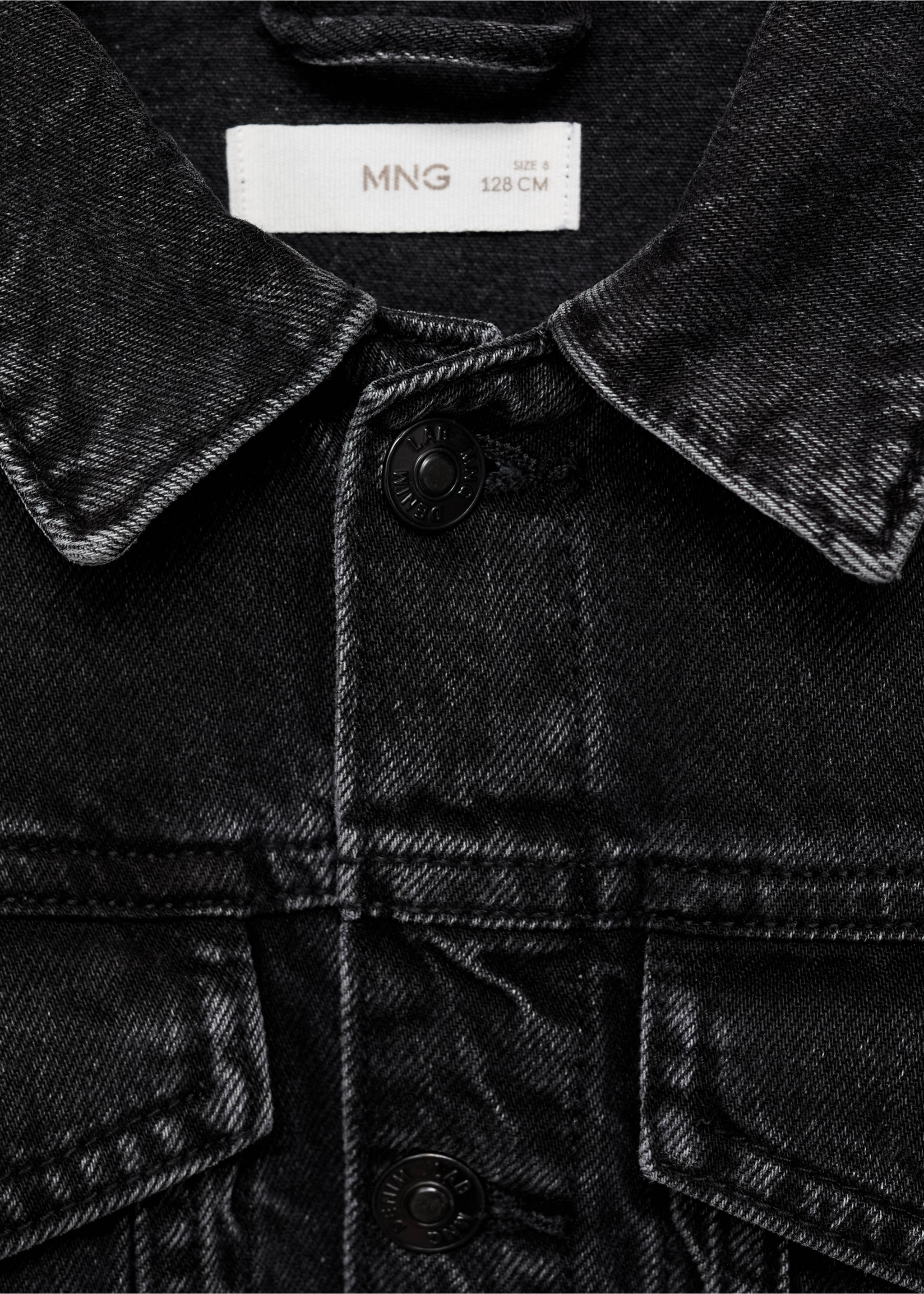 Close-up of a dark grey kids denim jacket collar and button placket, Black denim. Ref: 87045952-00.