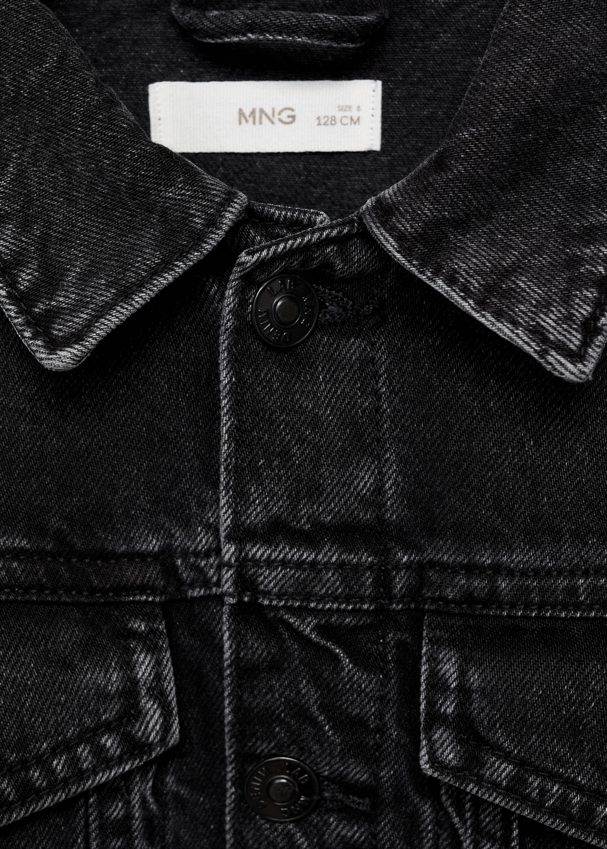 Close-up of a dark grey kids denim jacket collar and button placket