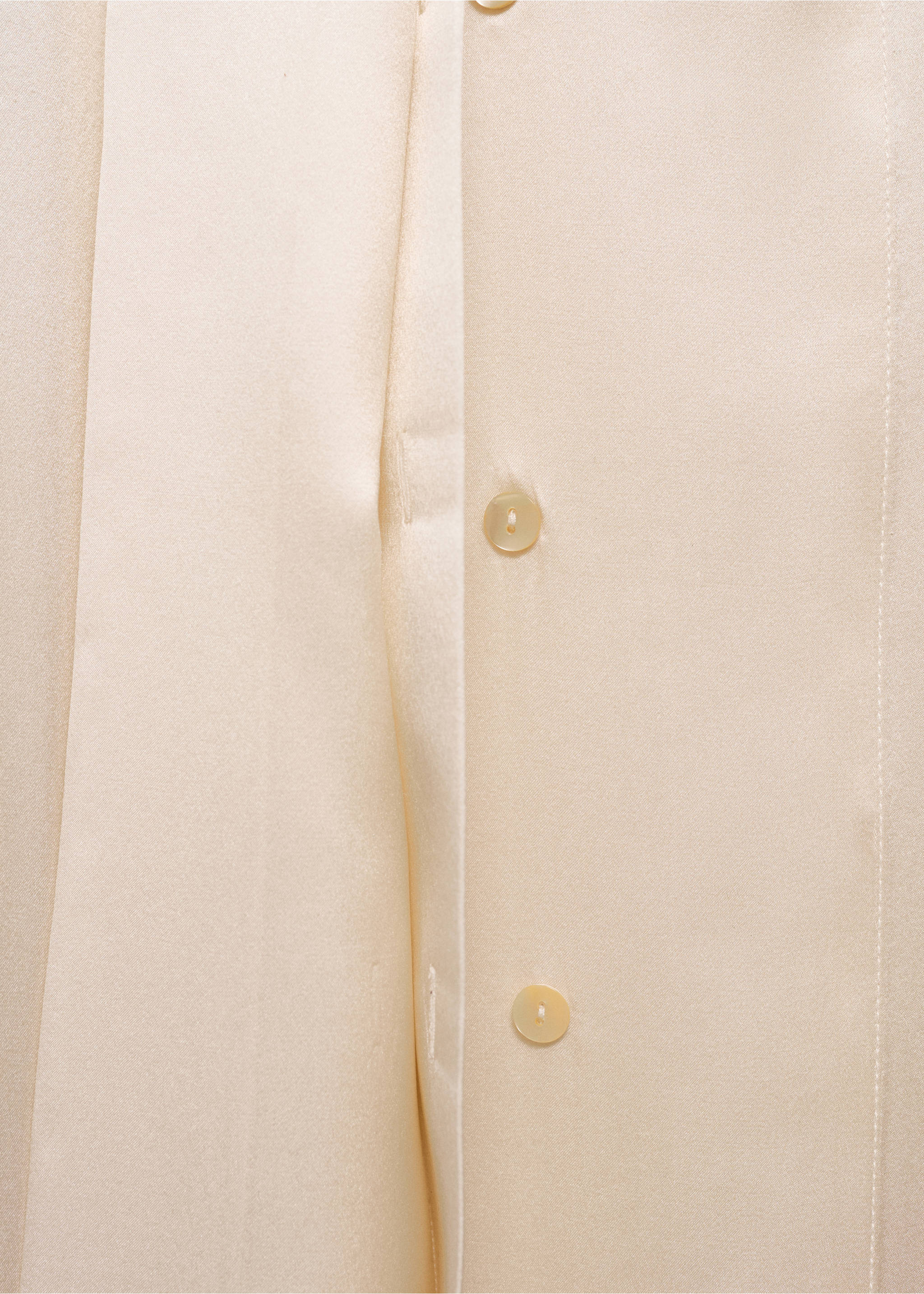 Close-up of fabric and button closure details on a light beige shirt., Ecru. Ref: 87045969-00.