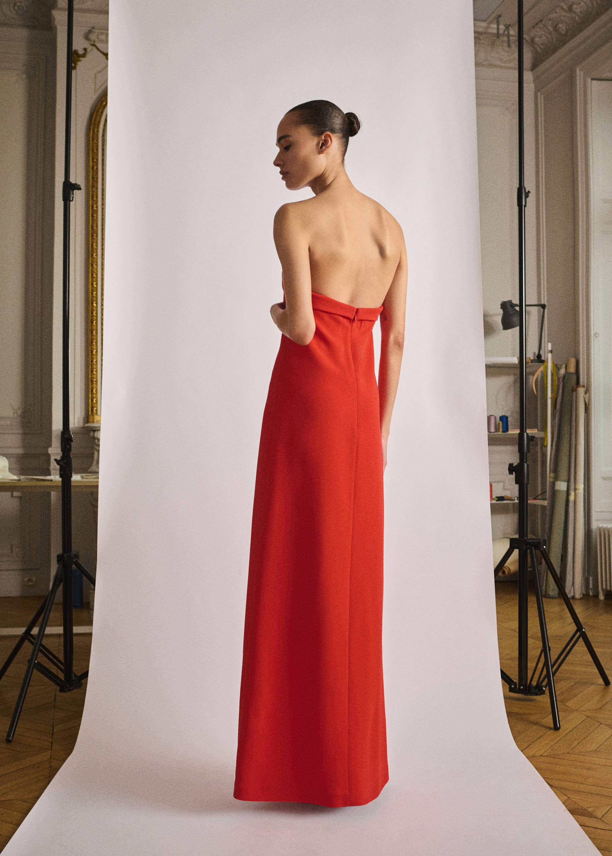 Back view of a strapless red long dress.