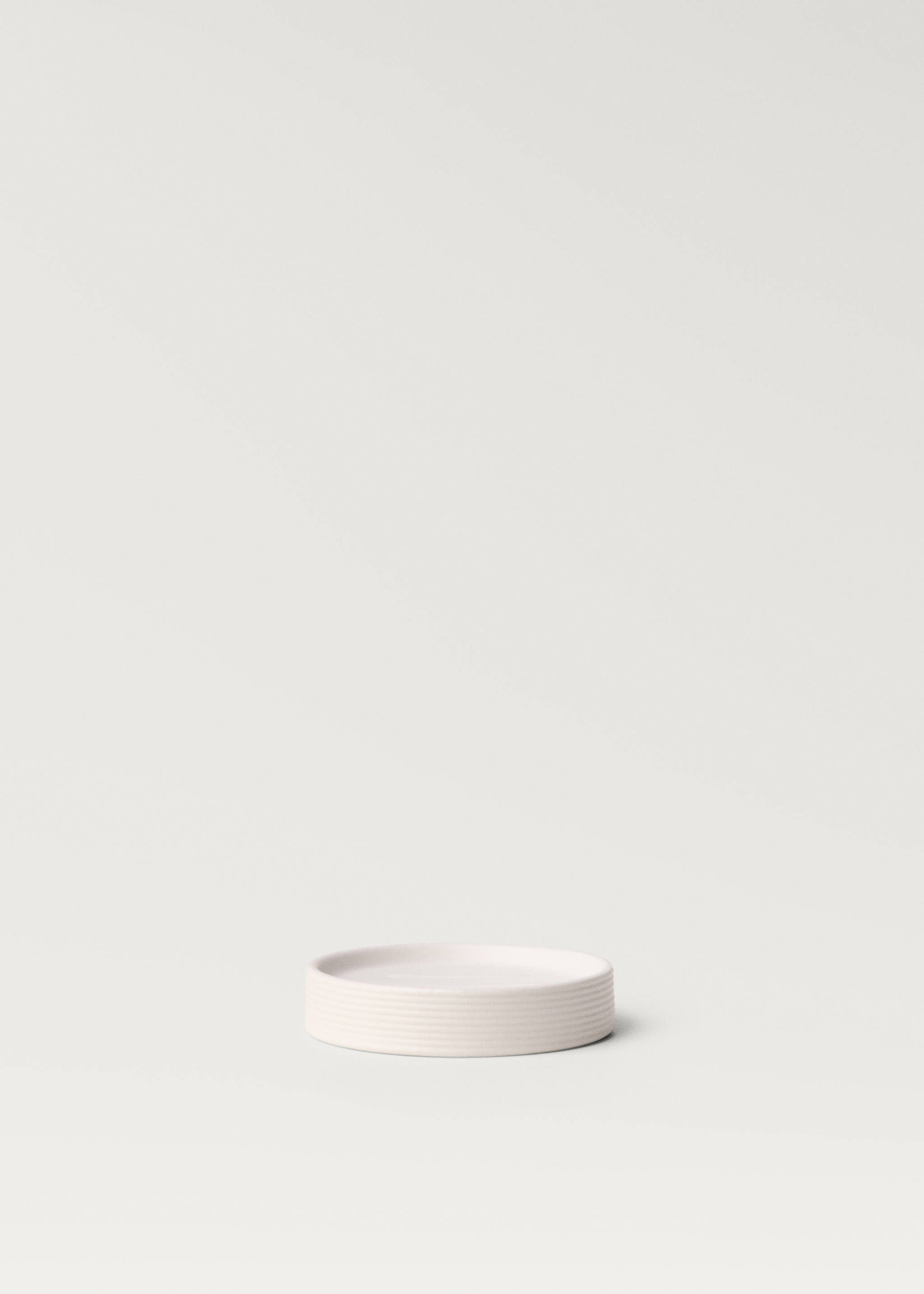 Pale pink round soap dish with subtle horizontal ribbing.