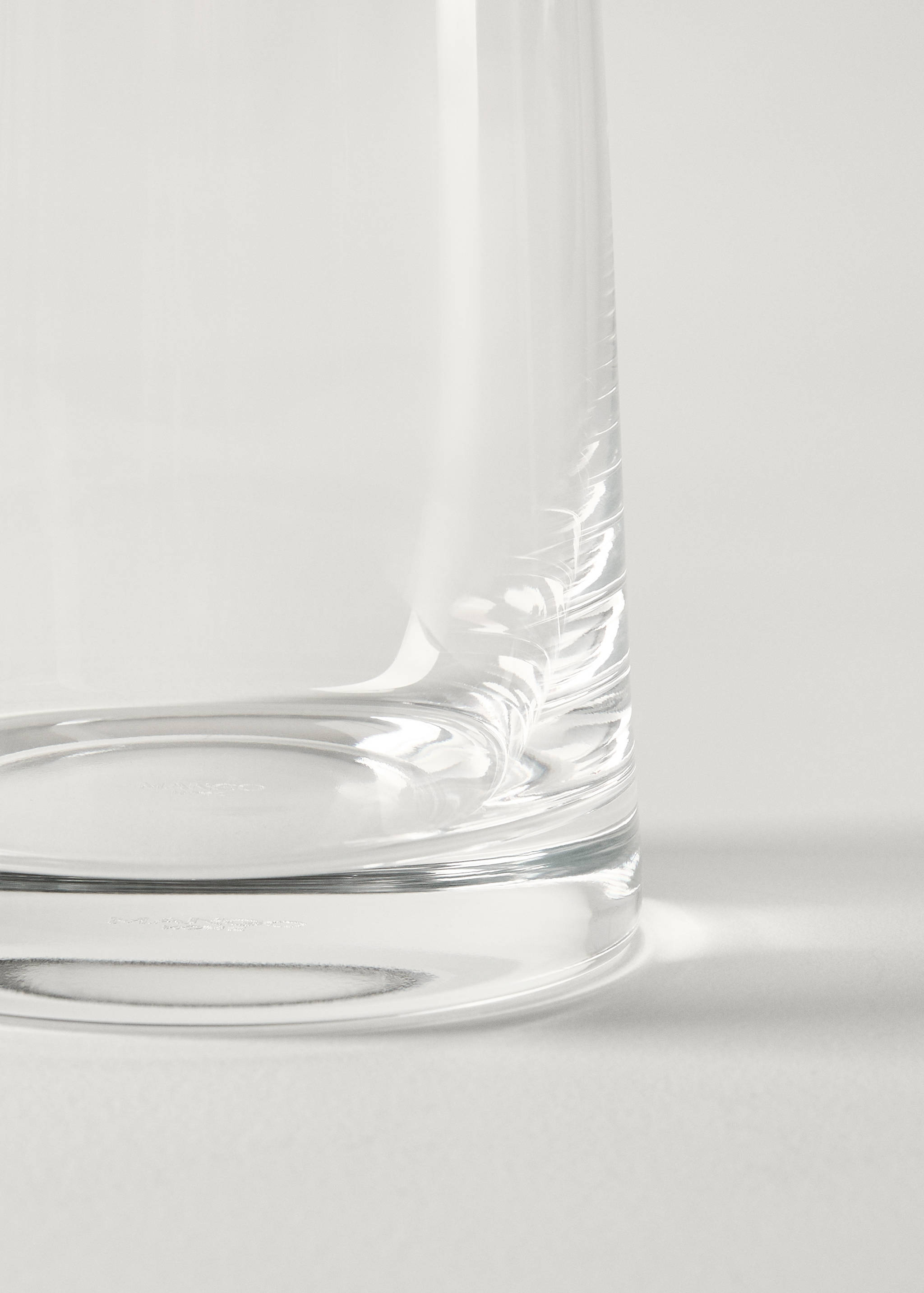 Close-up of a clear glass vase base.