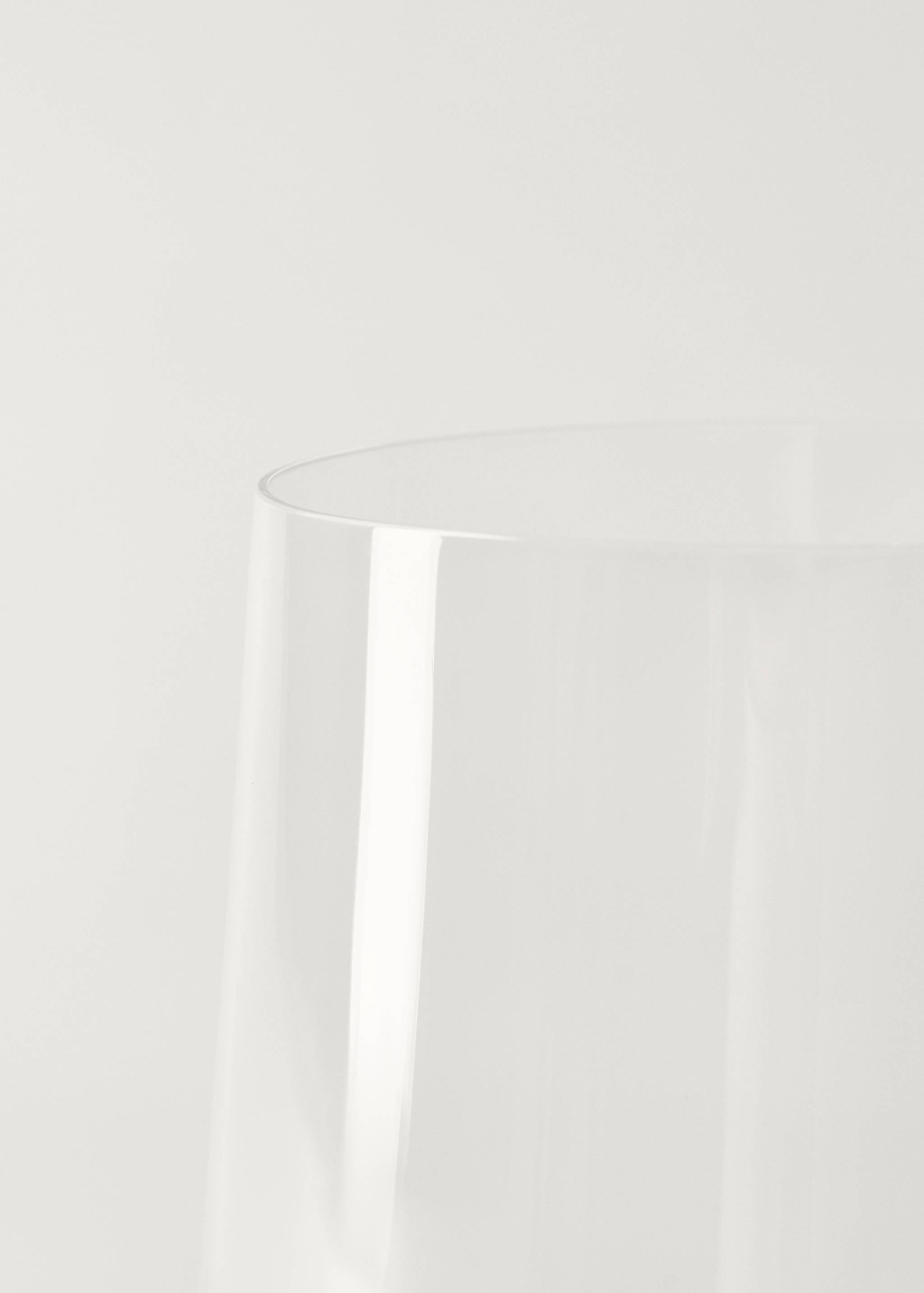 Close-up of the rim and transparent glass body of a clear vase.