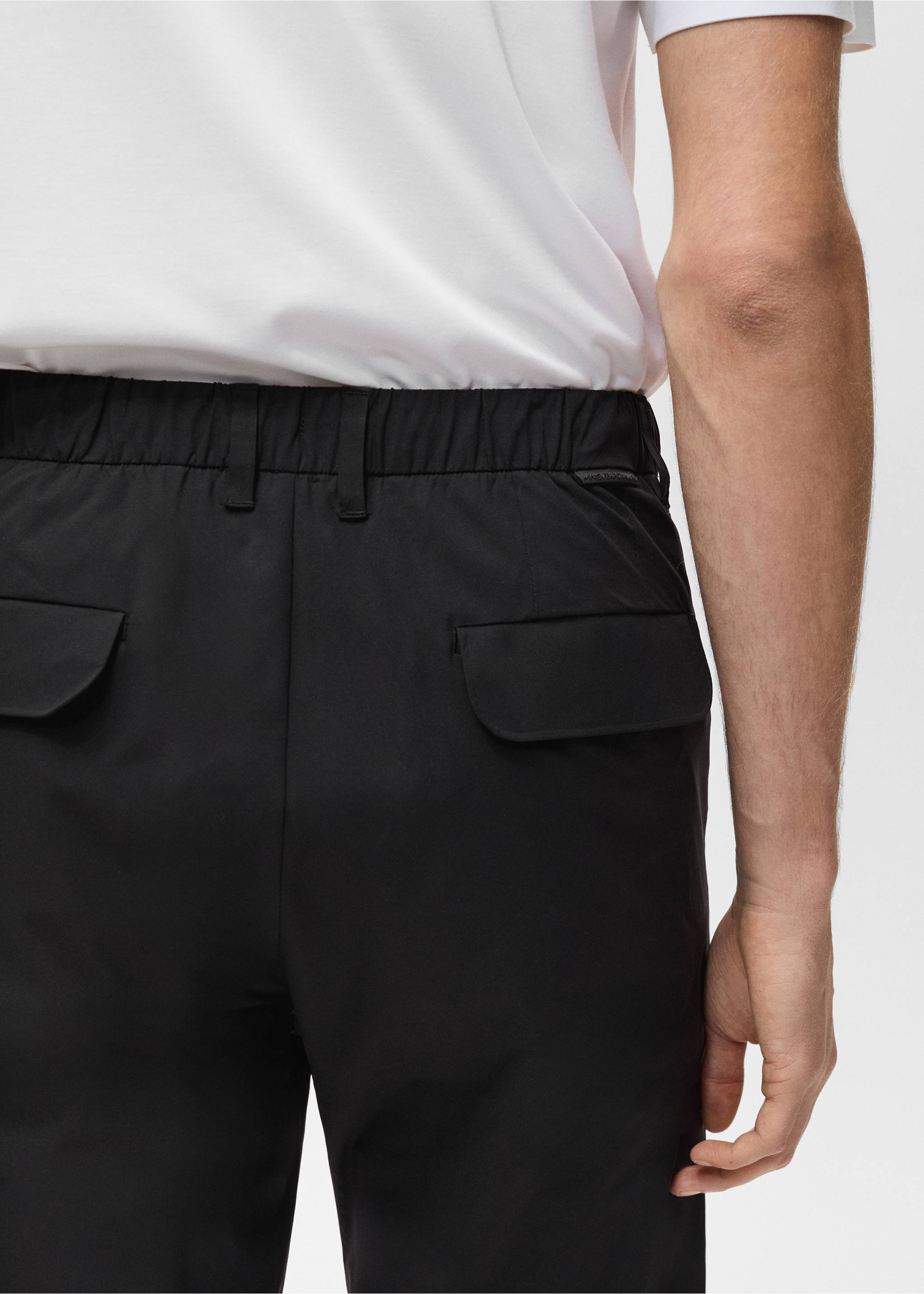 Black trousers with an elasticated waistband and back flap pockets, worn with a white t-shirt., Black. Ref: 87064389-00.