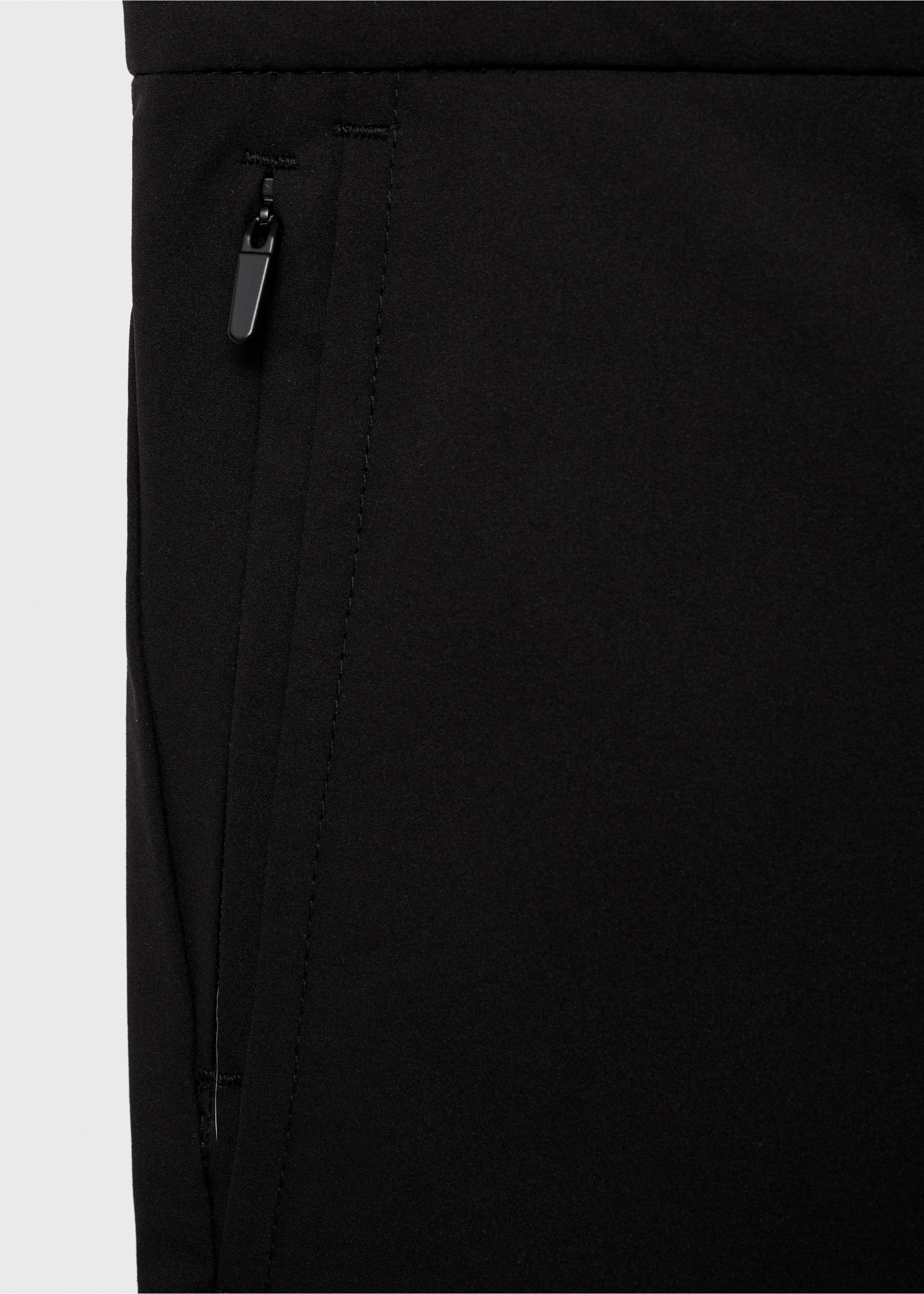 Close-up of black trousers showing the fabric texture and zipped pocket., Black. Ref: 87064389-00.