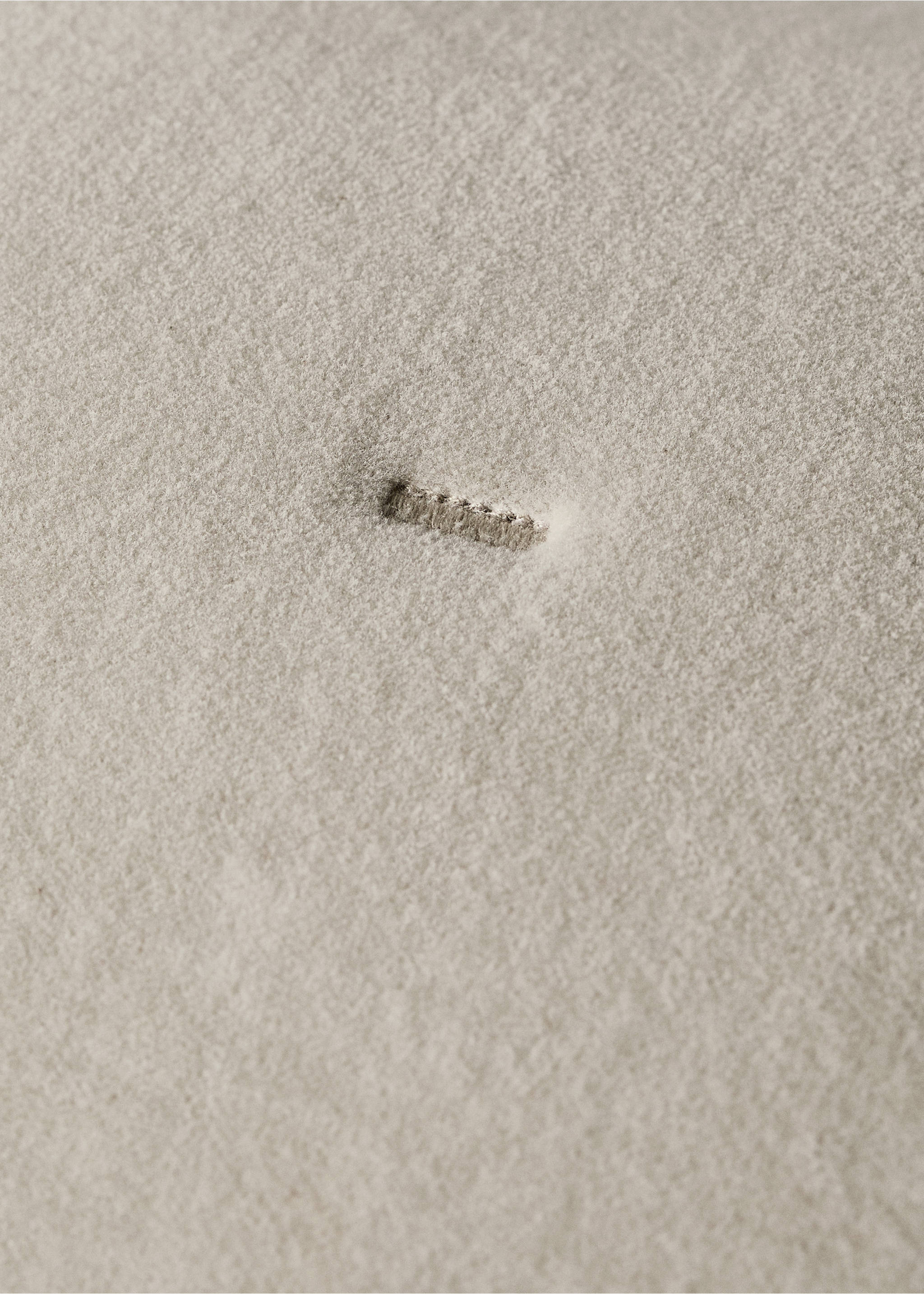 Close-up of a beige cushion cover showing fabric texture and a buttonhole., Light/Pastel Grey. Ref: 87065144-00.