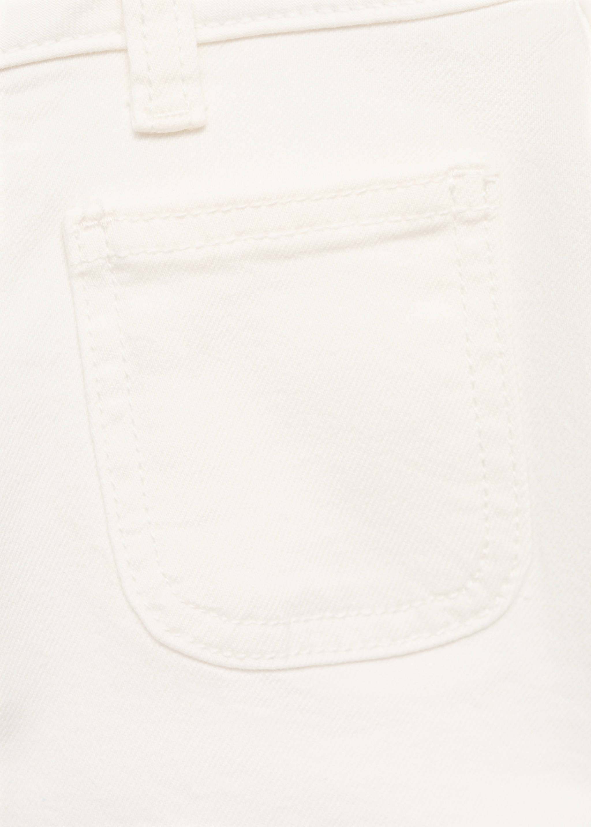 Close-up of white shorts showing back pocket detail.