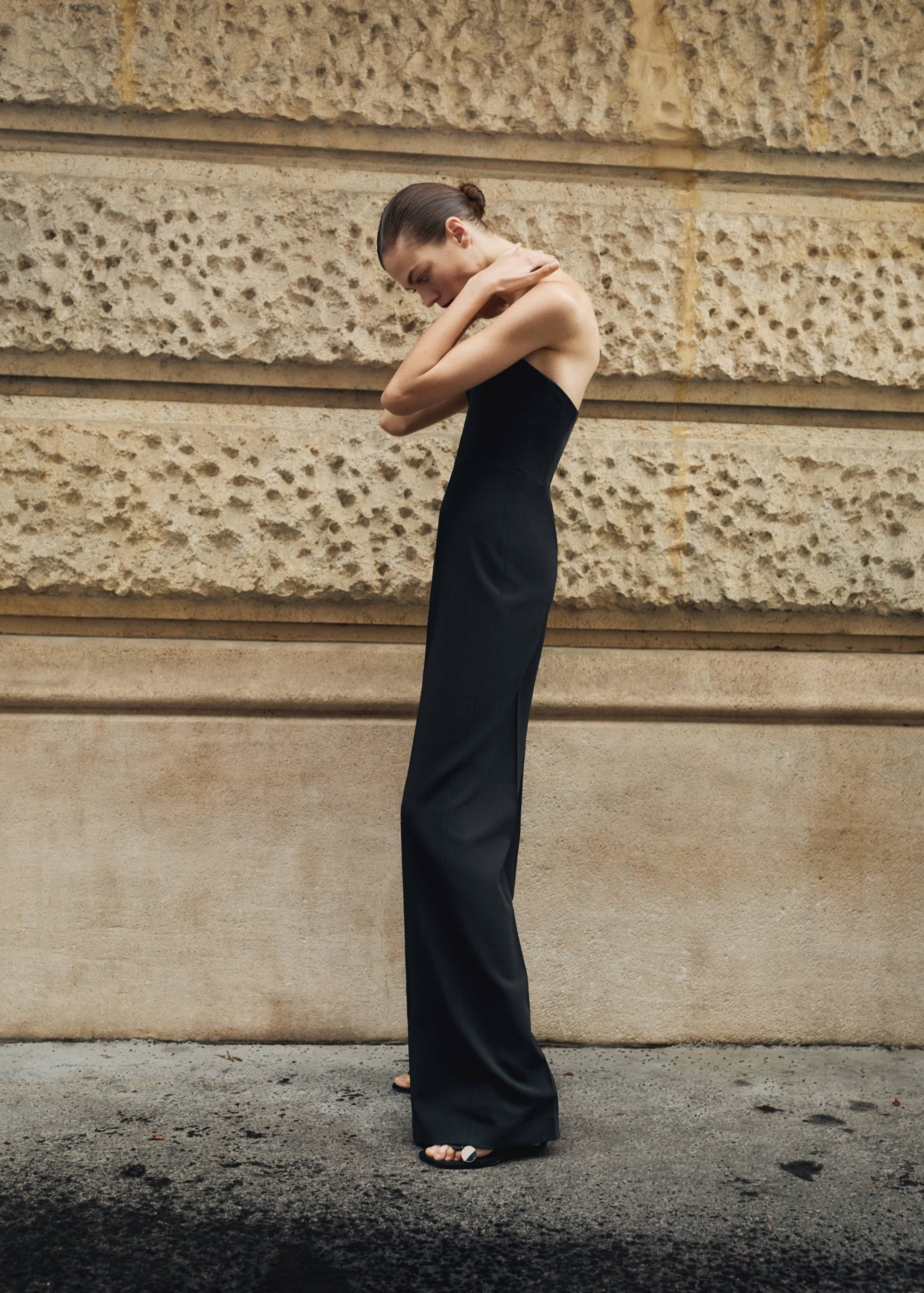 Black strapless jumpsuit with a long, straight-leg silhouette.