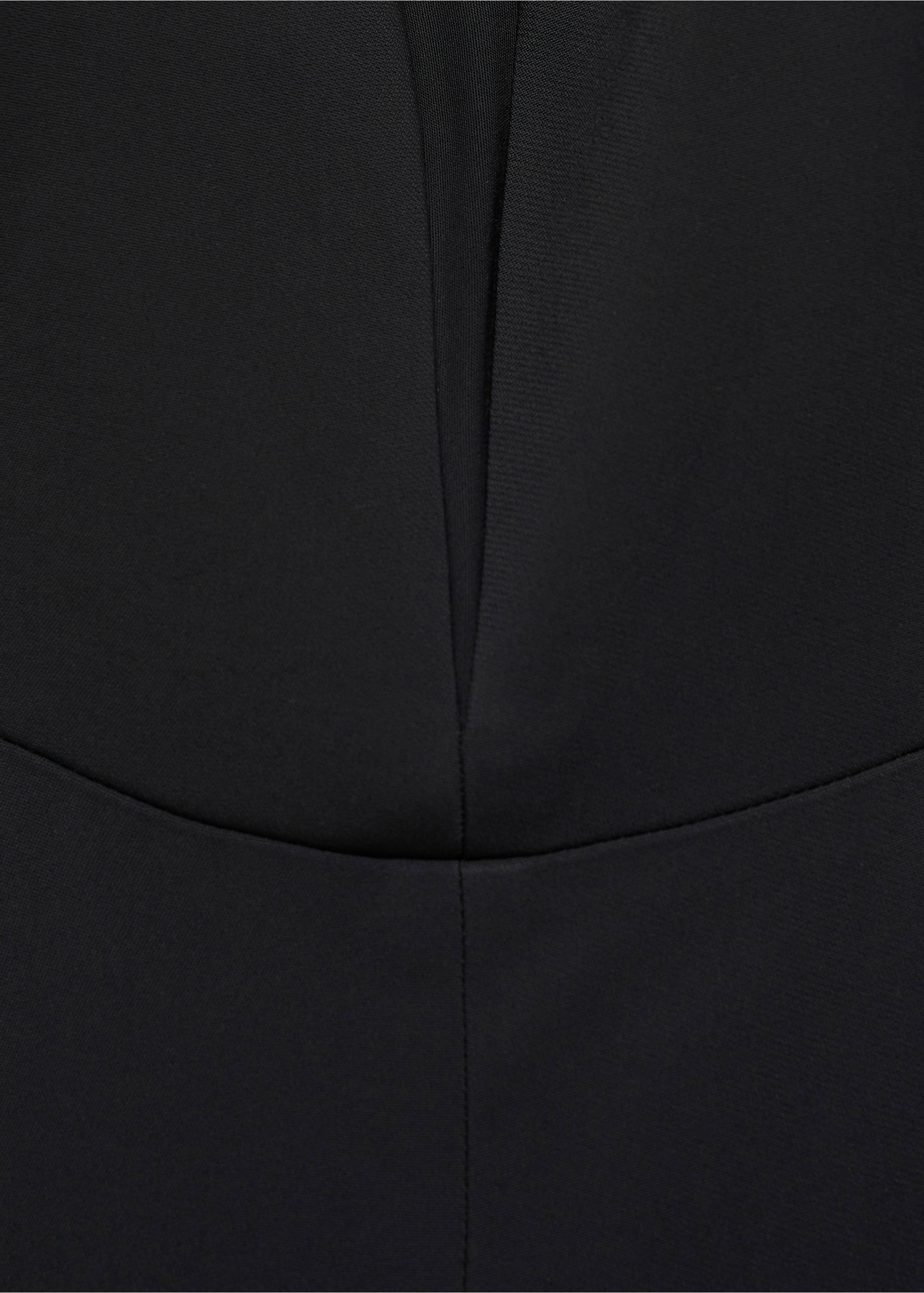 Close-up of fabric and neckline detail on a black jumpsuit., Black. Ref: 87070423-00.