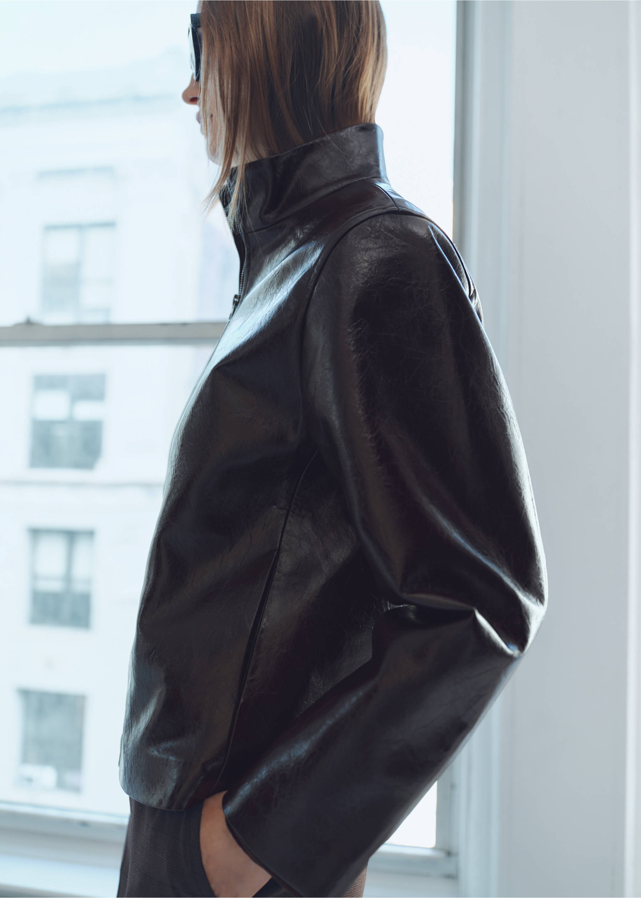Dark brown glossy jacket with a high collar in a close-up model view., Brown. Ref: 87070640-00.