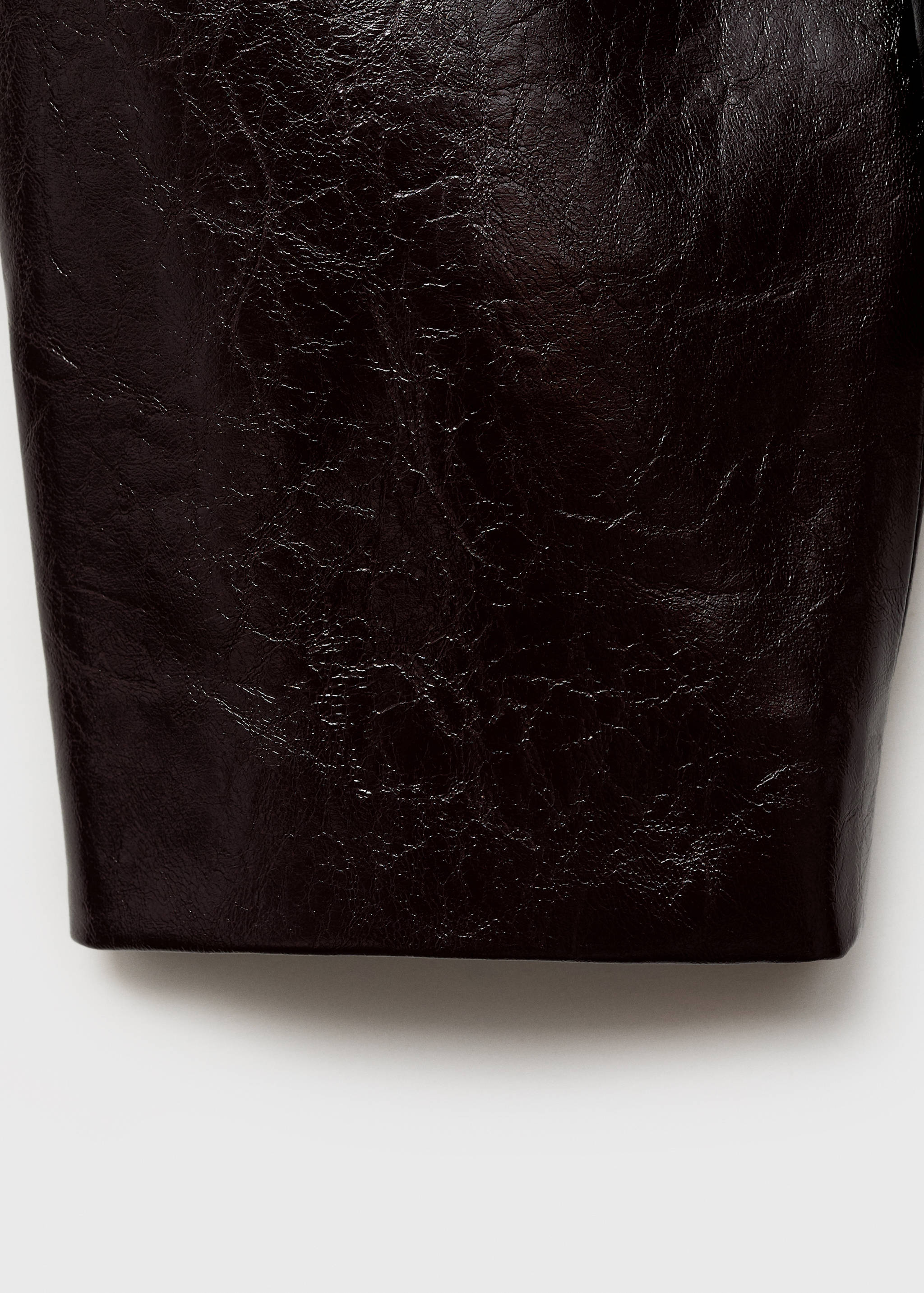 Close-up of a dark brown jacket fabric with a glossy, crinkled texture.