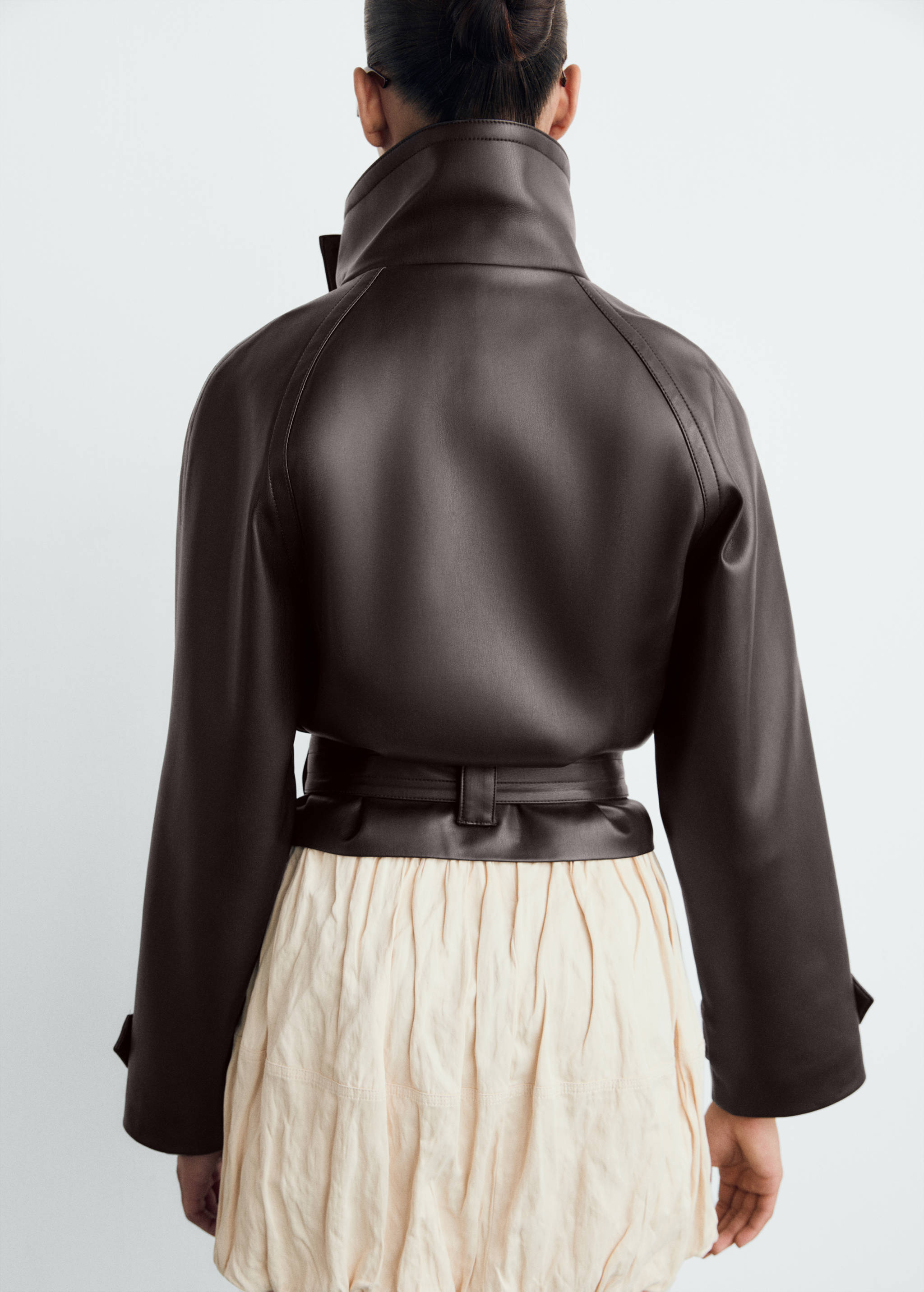 Dark brown jacket with high collar and belt, shown from the back.