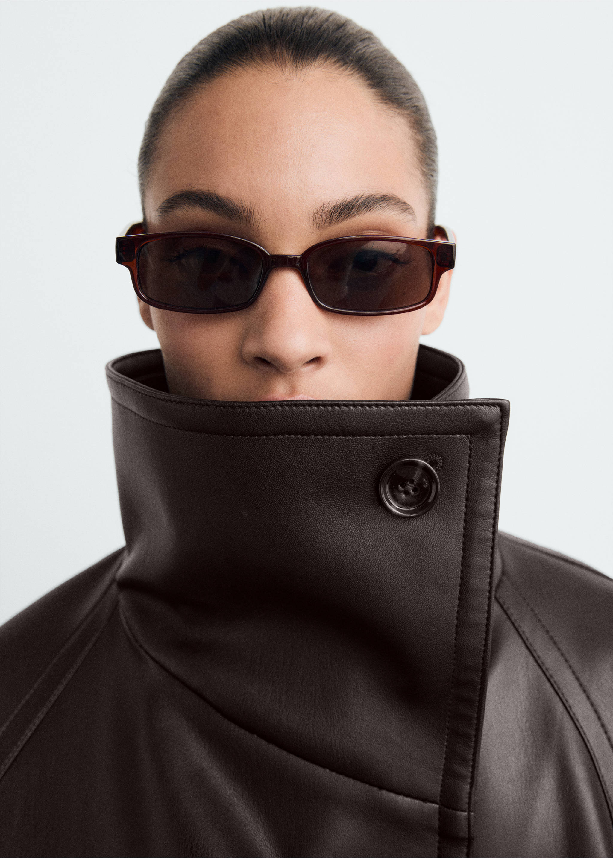 Close-up of a dark brown jacket with a high collar and button fastening., Brown. Ref: 87070651-00.