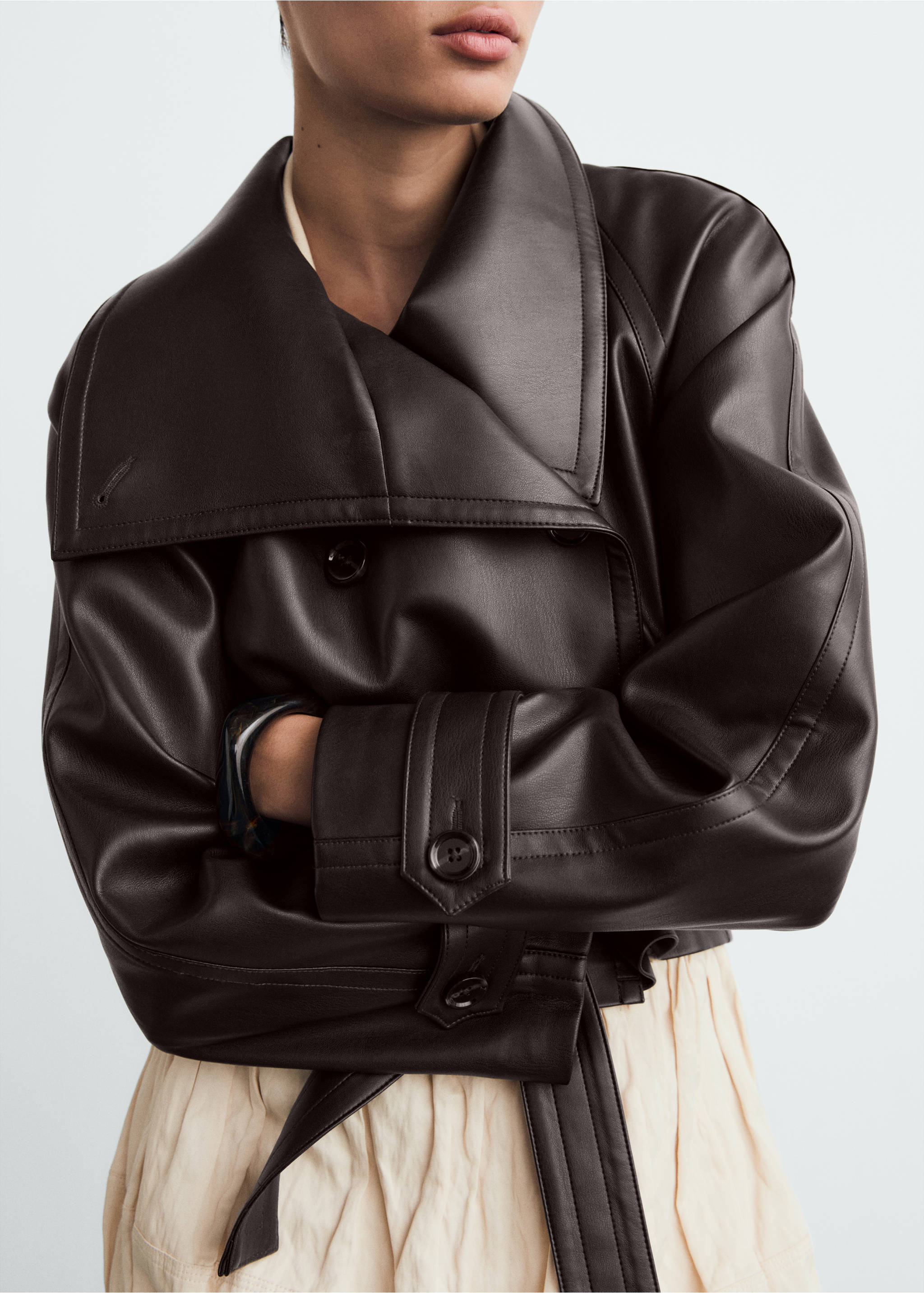 Dark brown faux-leather jacket with an oversized lapel, double-breasted buttons, and a matching waist belt., Brown. Ref: 87070651-00.