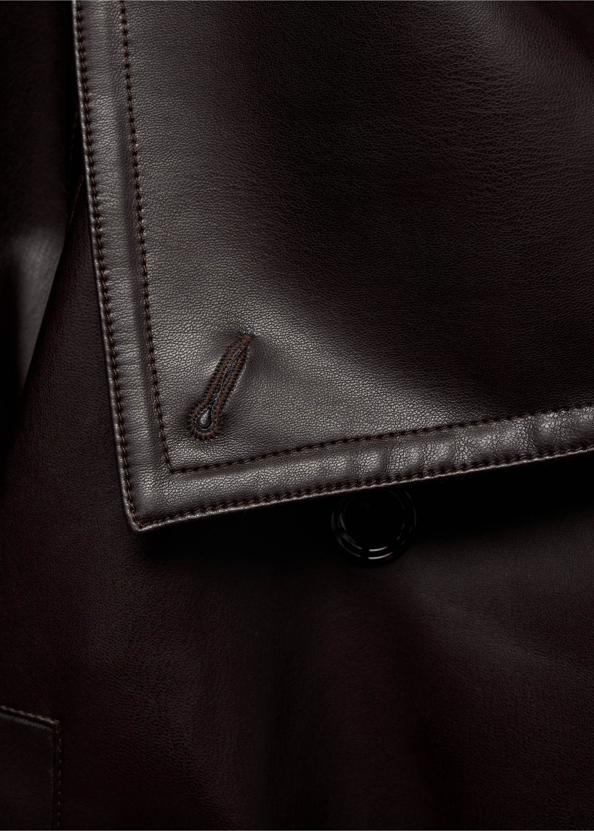 Close-up of a dark brown leather jacket showing topstitched lapel detail., Brown. Ref: 87070651-00.