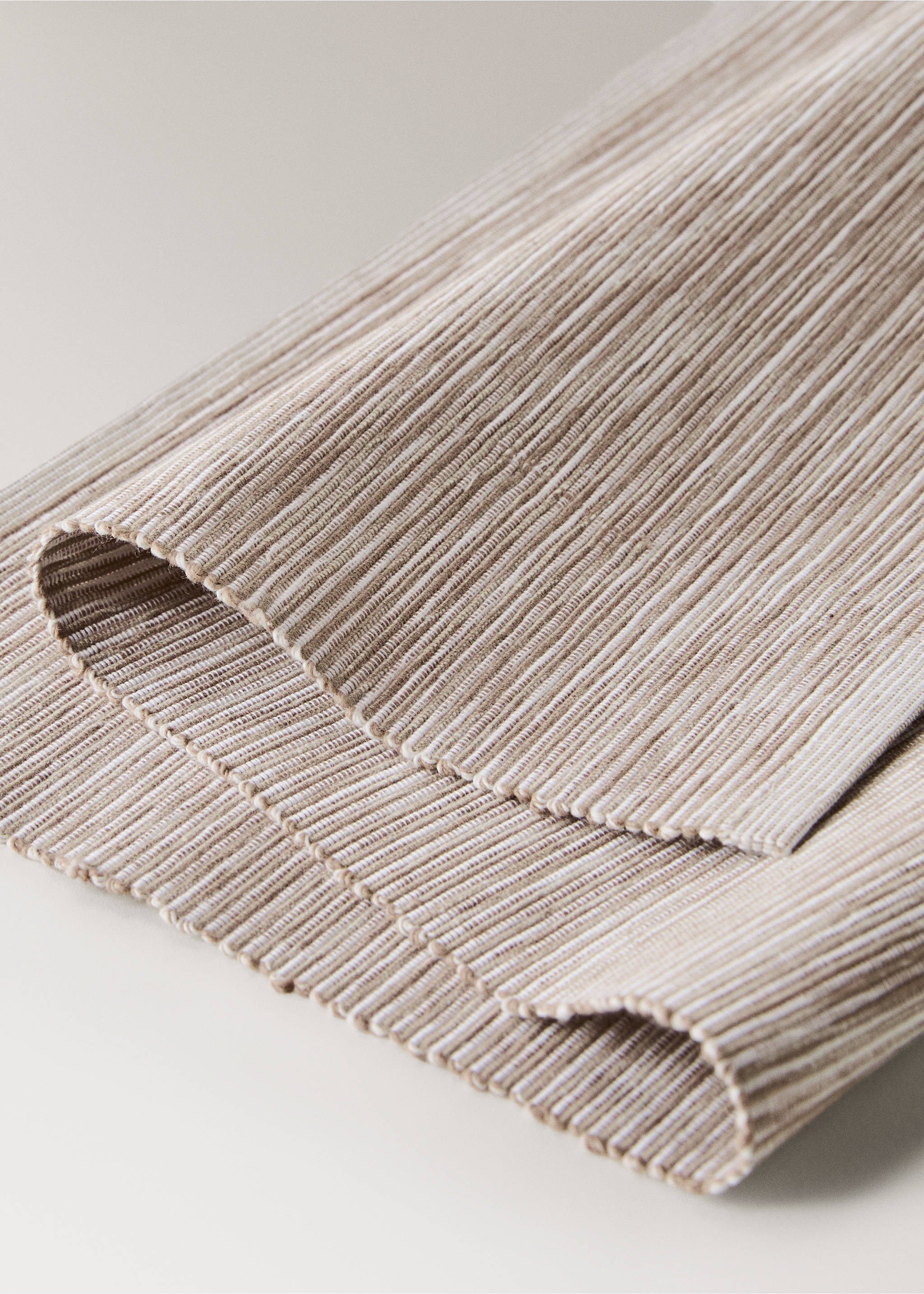 Close-up of a textured beige ribbed placemat., Sand. Ref: 87072978-00.