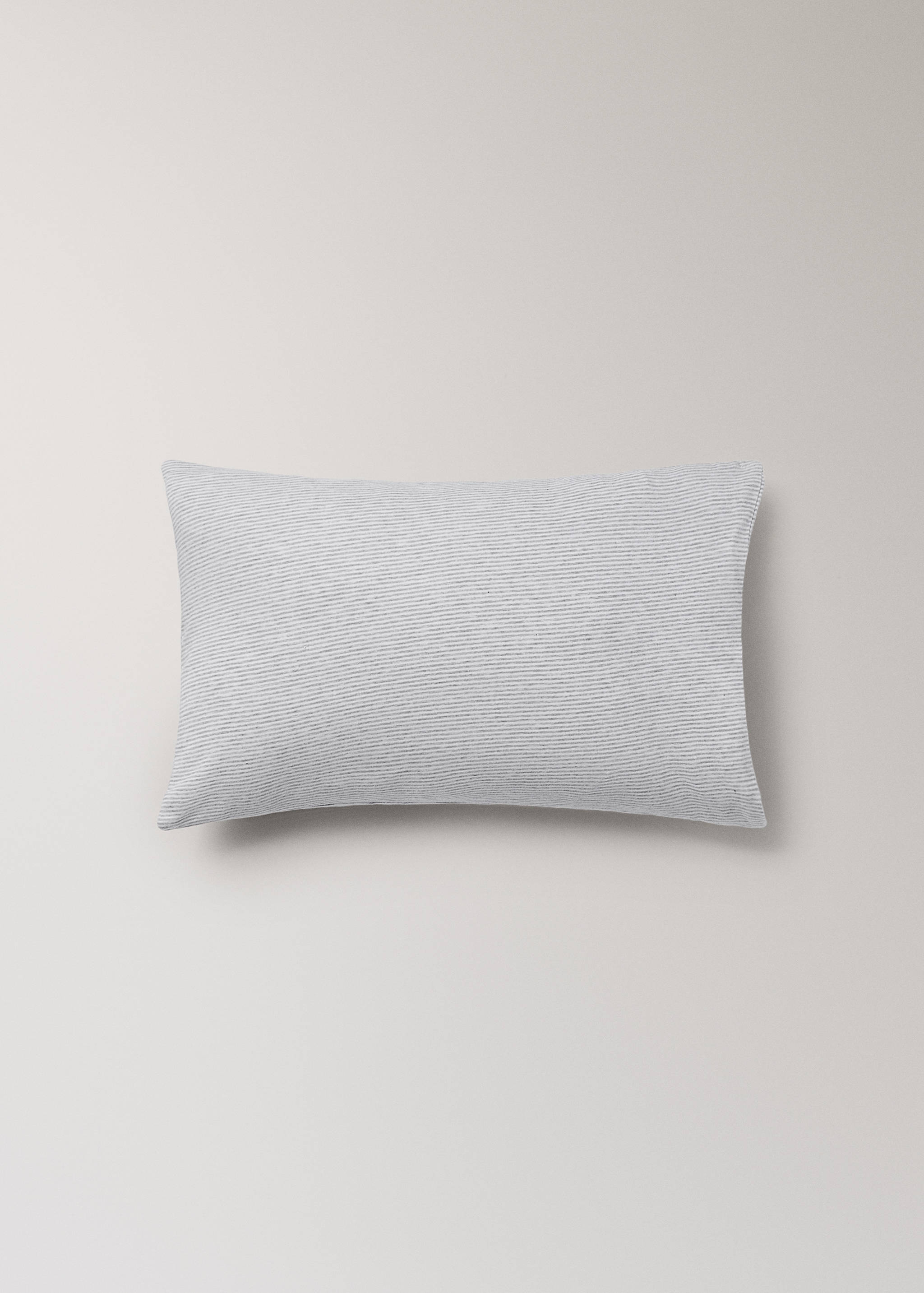 Grey and white striped cot pillowcase in a still life shot.