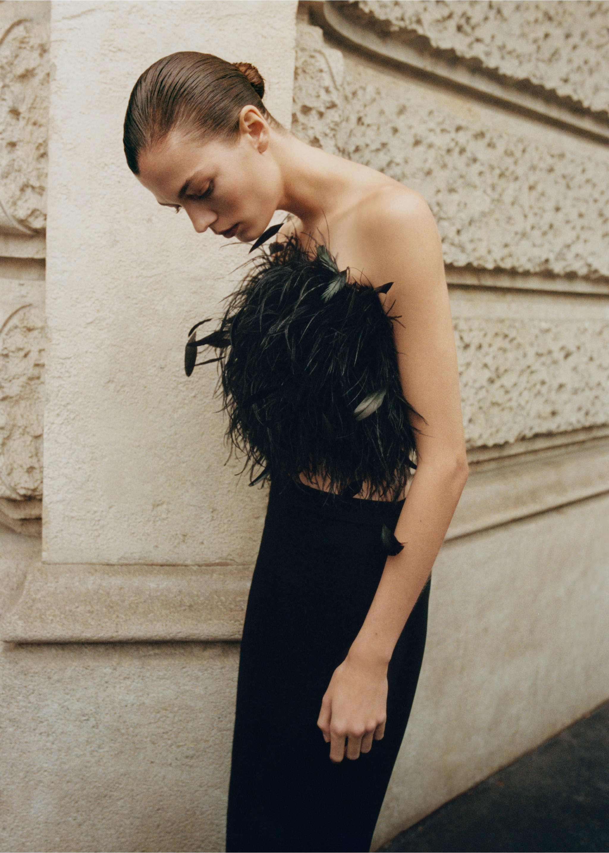 Black strapless feather top worn by a model in profile., Black. Ref: 87080423-00.