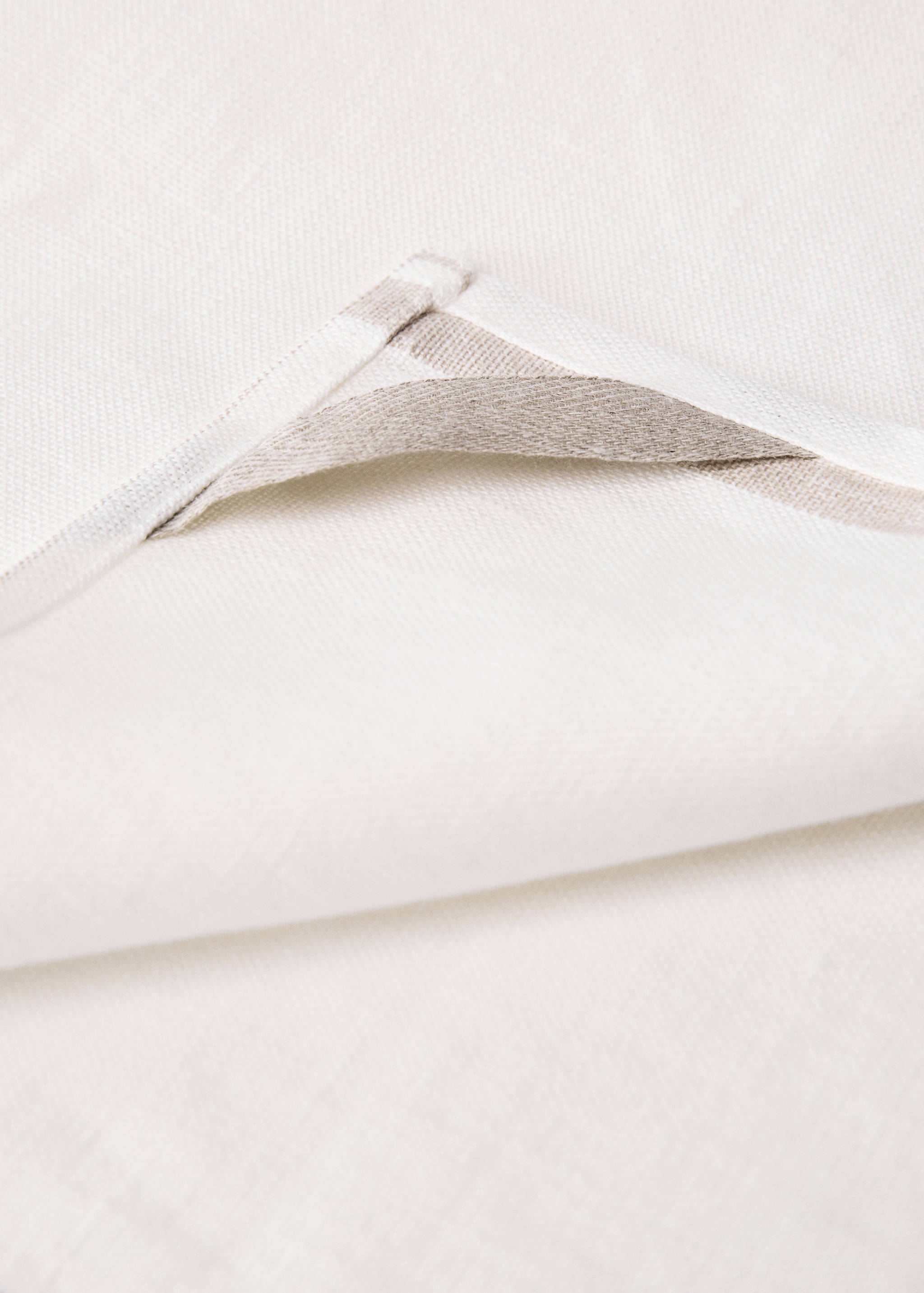 Close-up of an off-white kitchen towel corner detail.