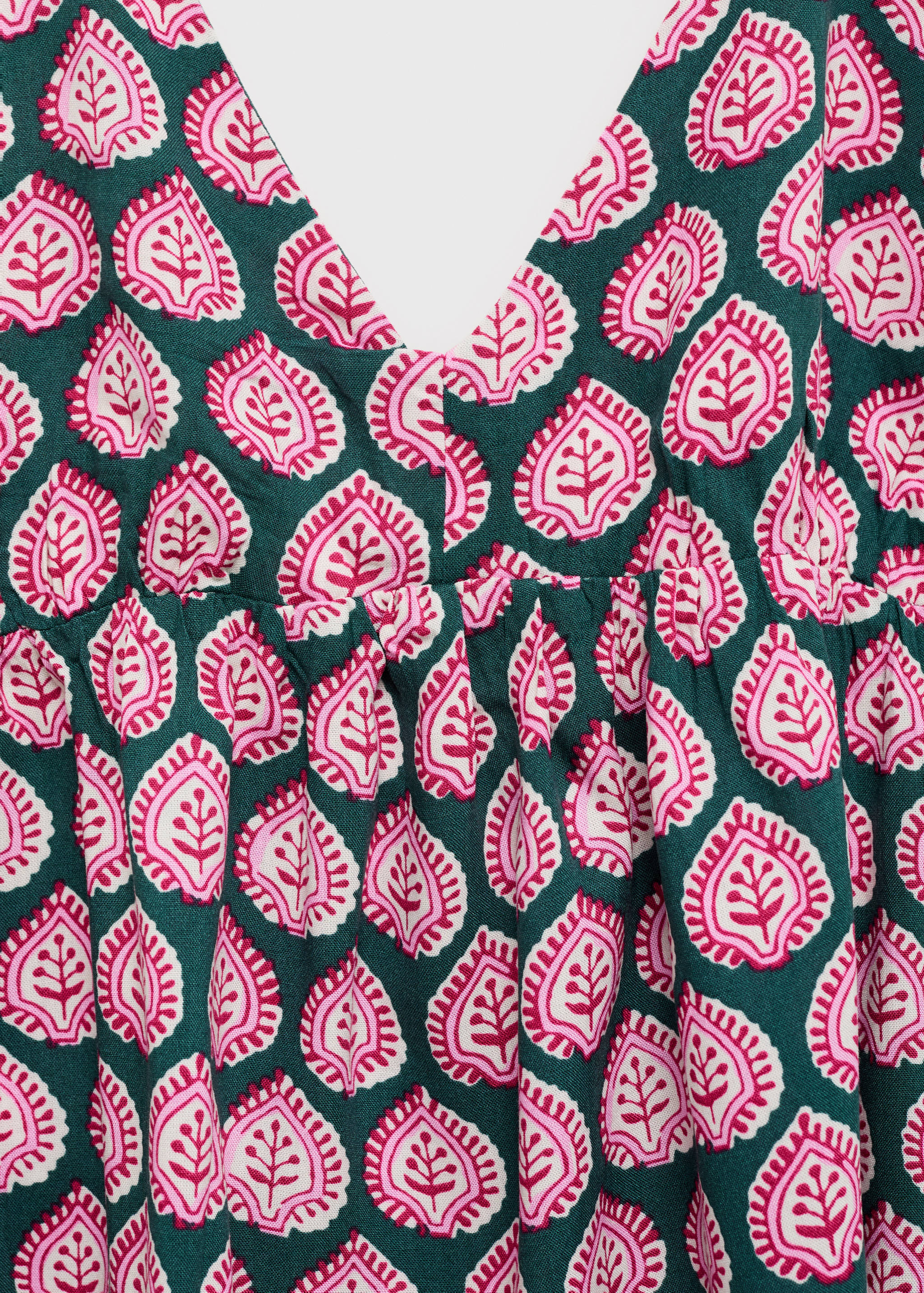 Green paisley print top with V-neckline and gathered bust.