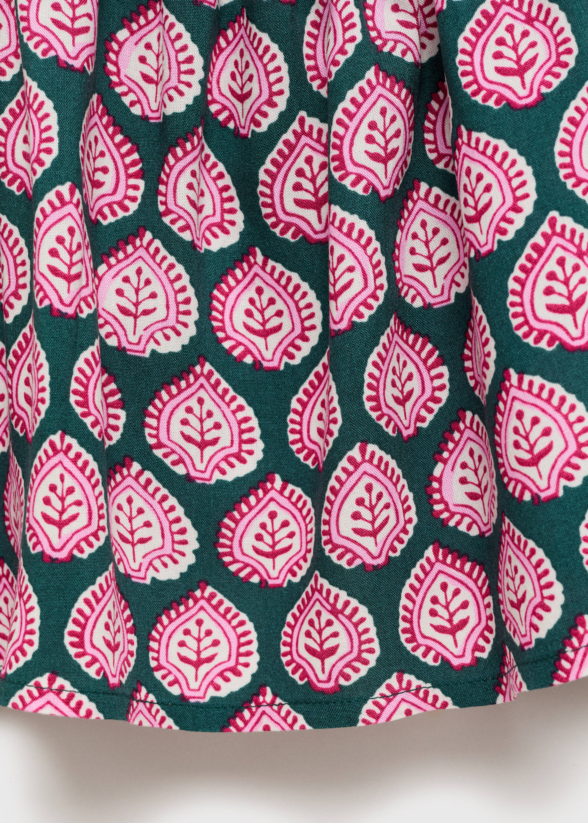 Close-up of the green top fabric with a pink and white paisley pattern.