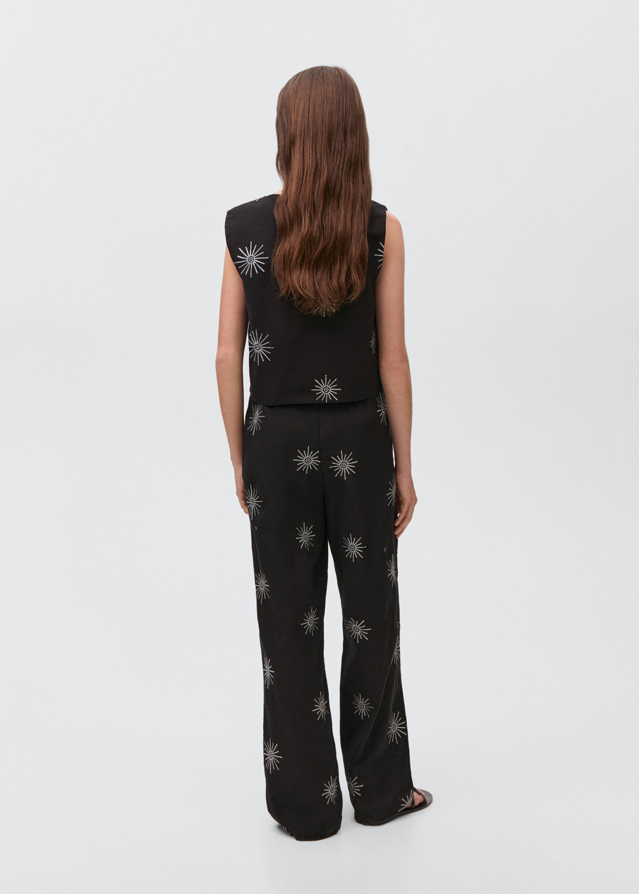 Long trousers with embroidered details - Reverse of the article