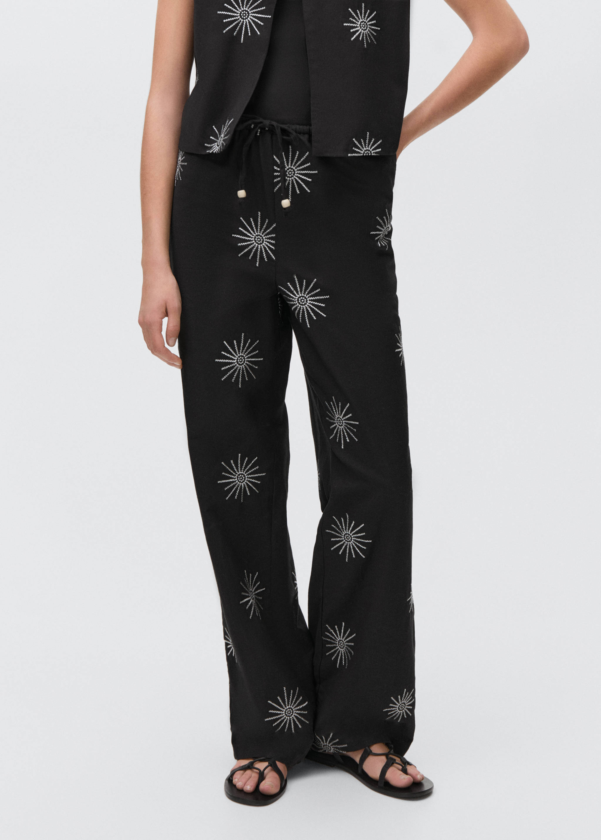 Long trousers with embroidered details - Details of the article 1