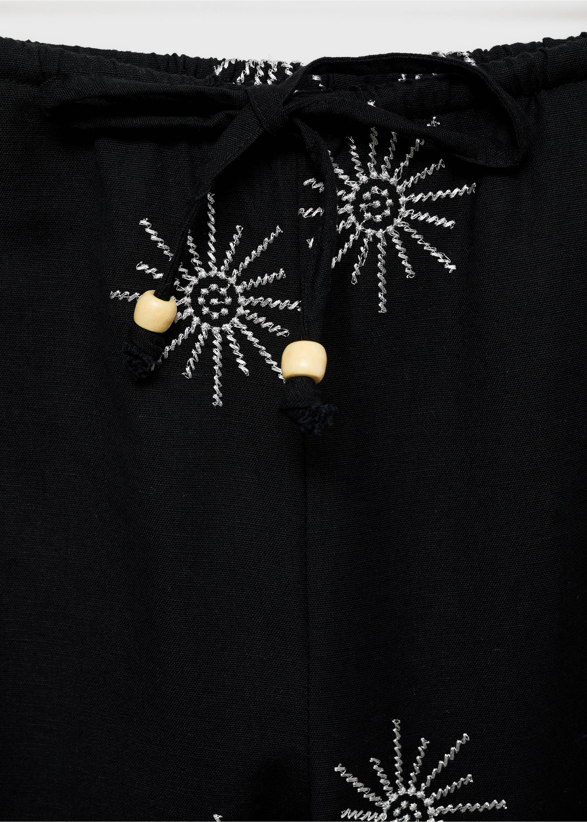 Long trousers with embroidered details - Details of the article 8, Black. Ref: 87095725-00.
