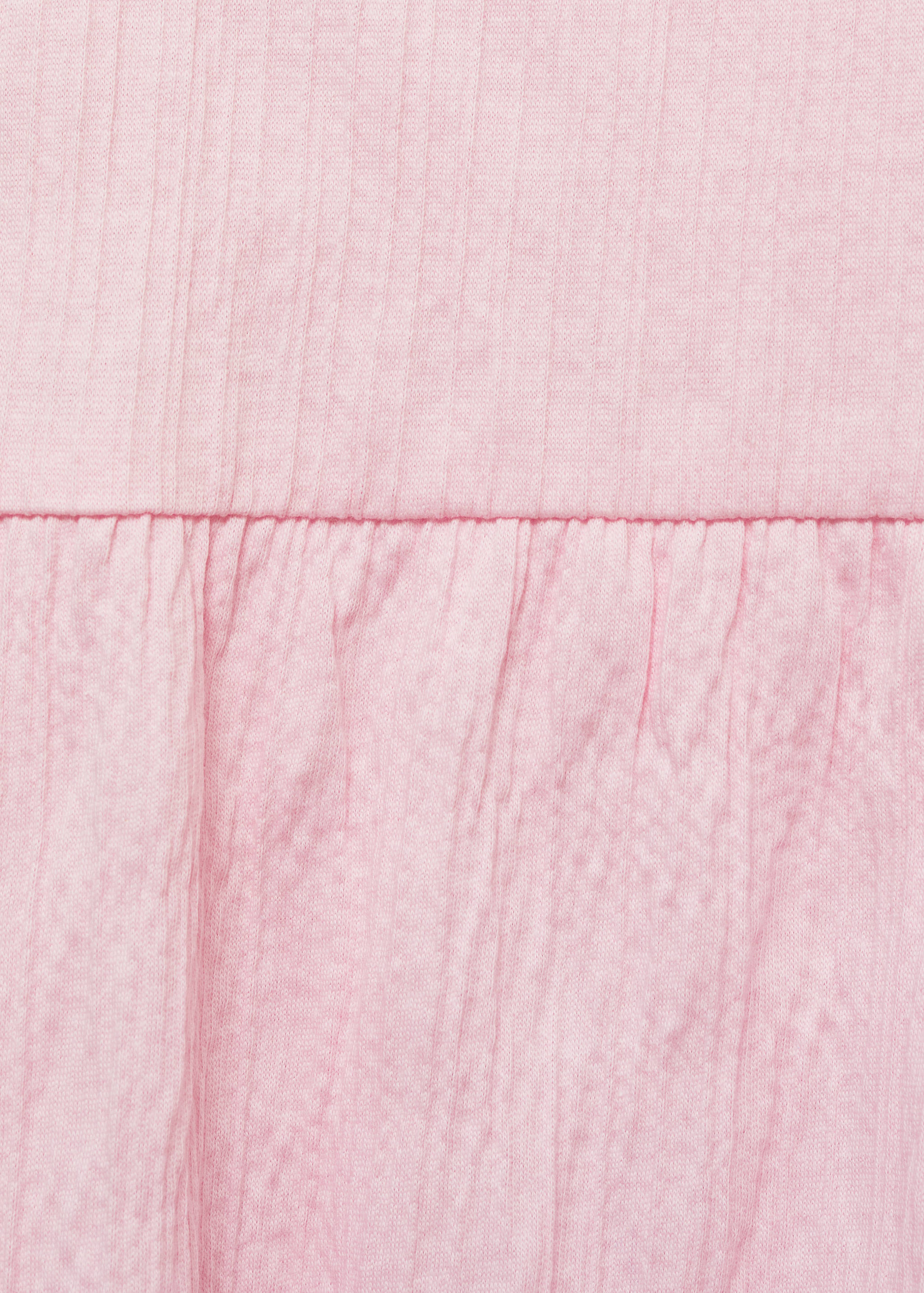 Pink top fabric detail showing a ribbed upper section and gathered woven lower panel.