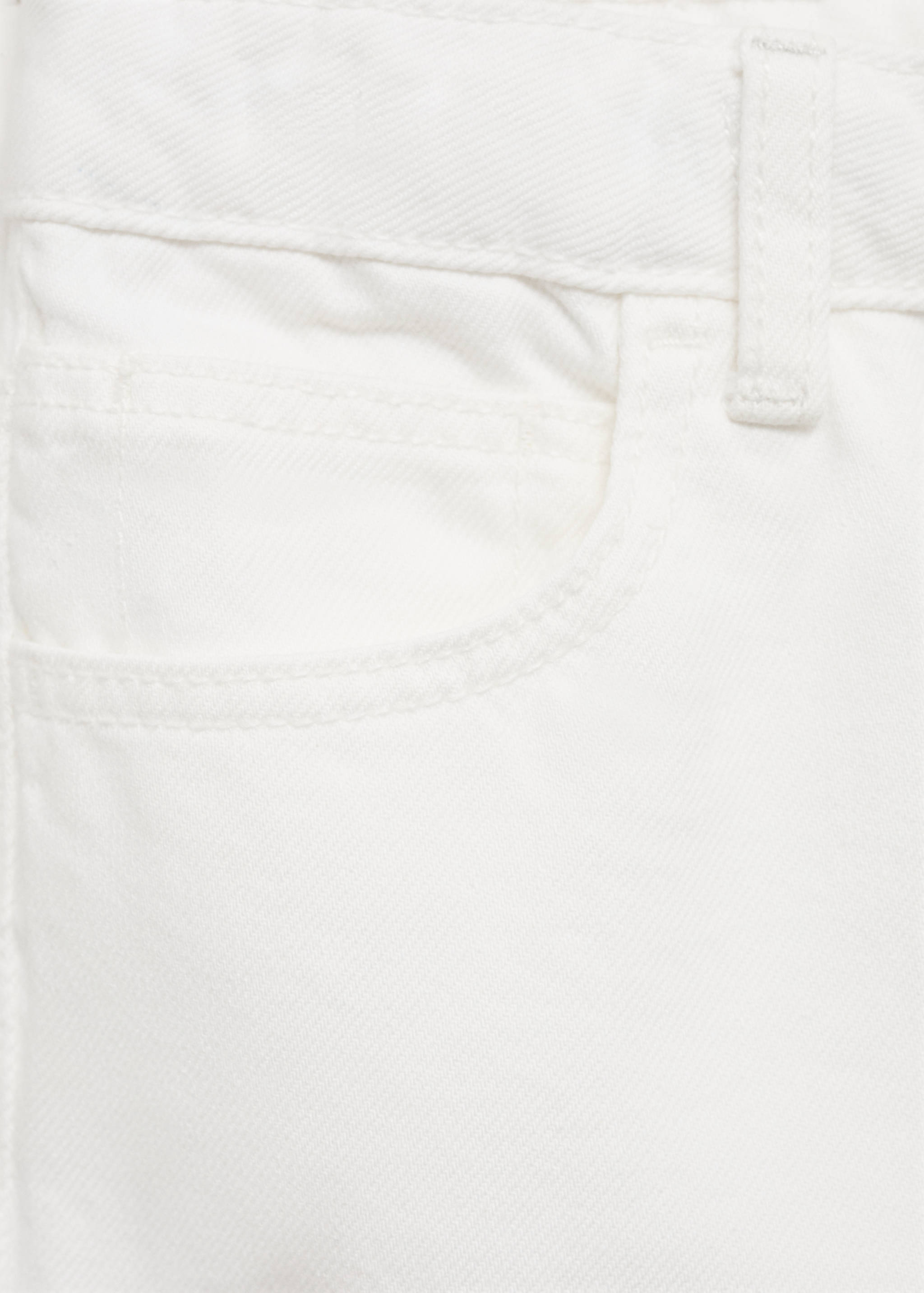 Close-up of off-white denim bermuda shorts fabric and pocket detail.
